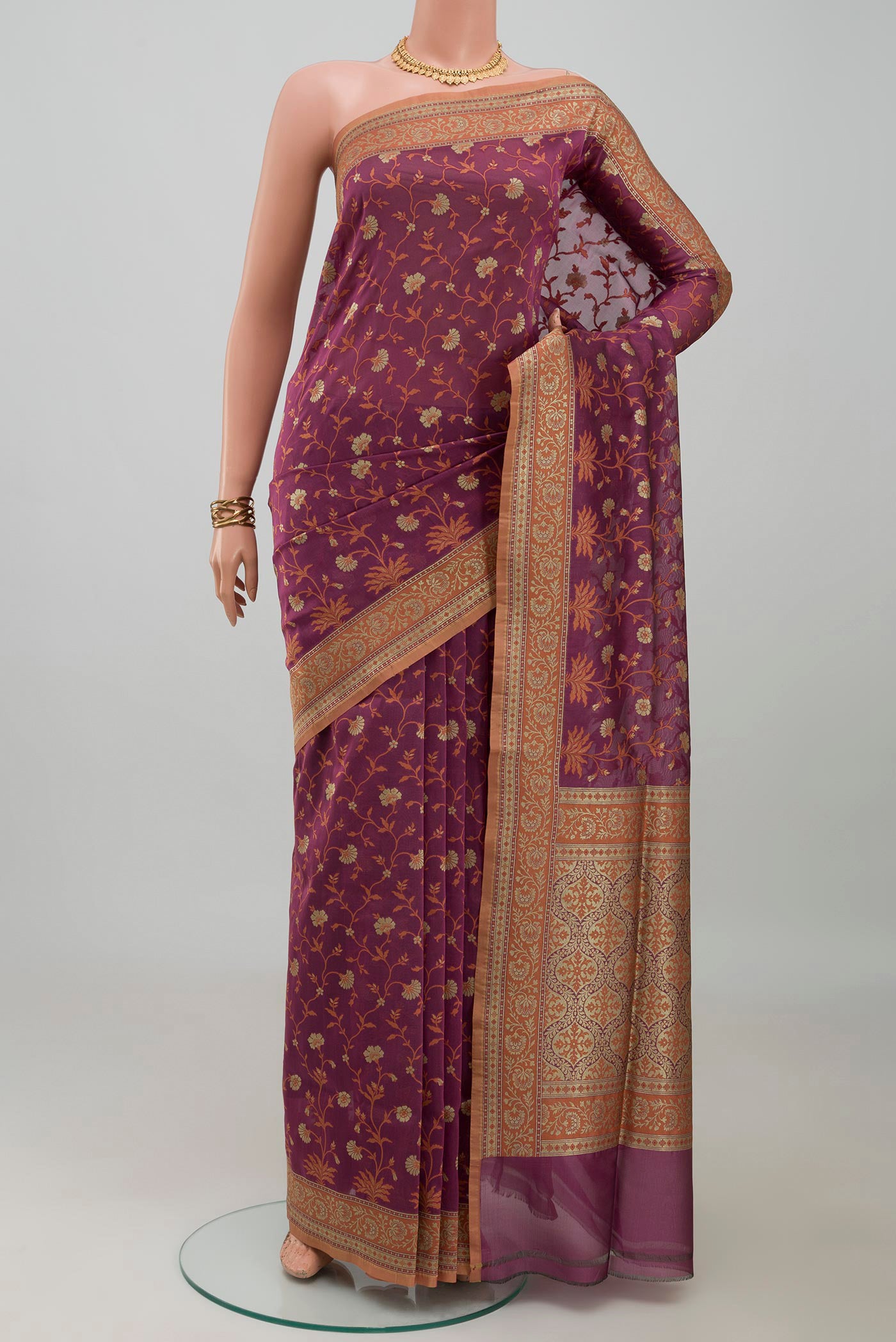 Mauve Banarasi Silk Saree with Zari And Thread Butta on the body and Zari Border.  displayed on a mannequin