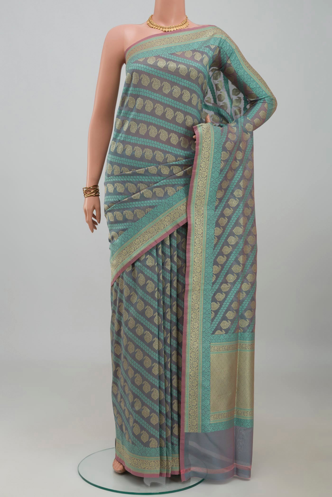 Grey Banarasi Silk Saree with Zari And Thread Butta on the body and Zari Border.  displayed on a mannequin