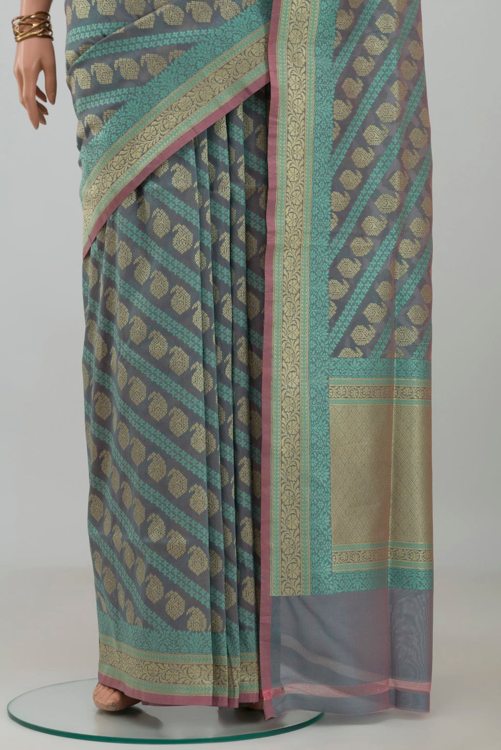 Pleats and pallu of Grey Banarasi Silk Saree with Zari And Thread Butta on the body and Zari Border. 