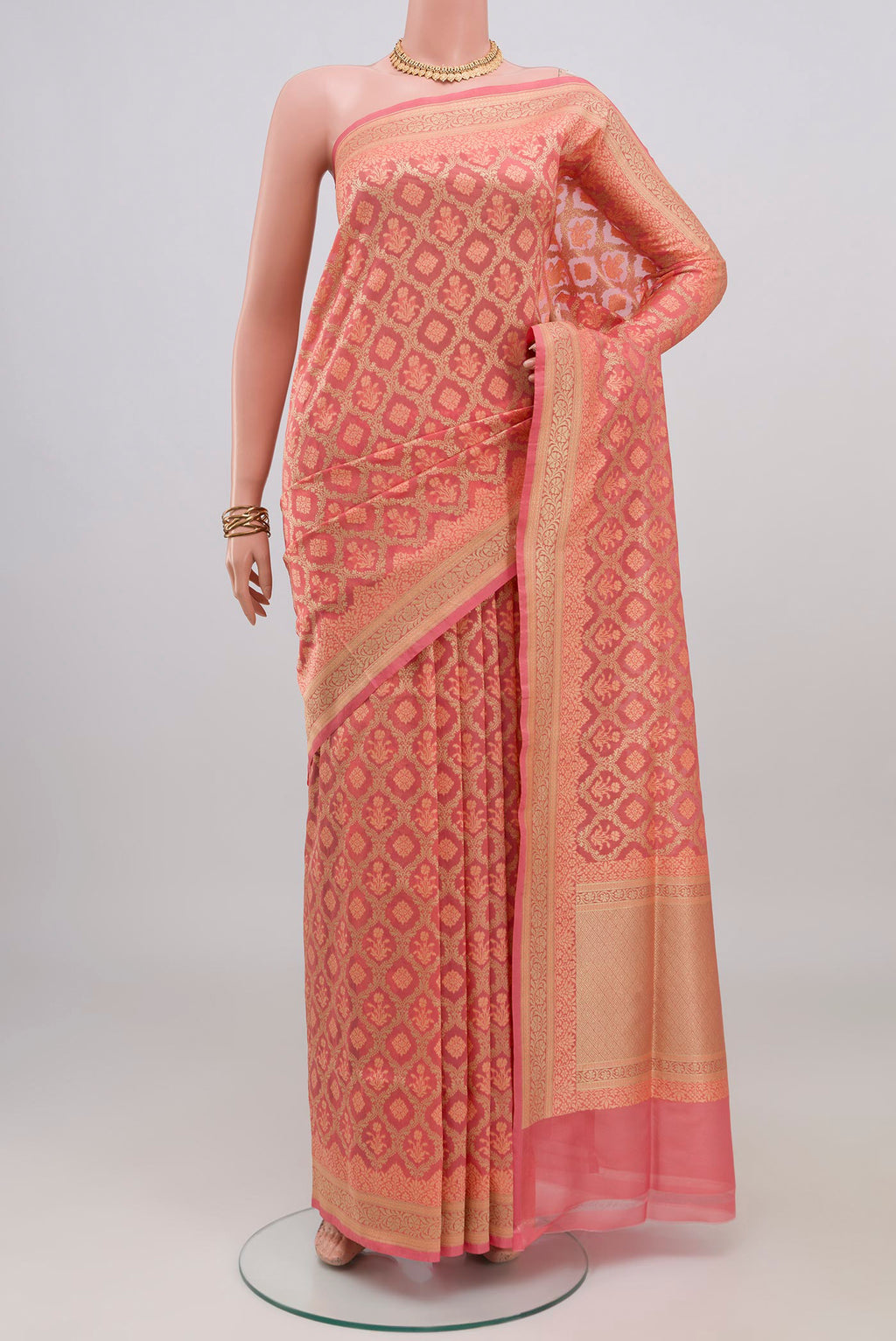 Peach Banarasi Silk Saree with Thread Butta on the body and Zari Border.  displayed on a mannequin