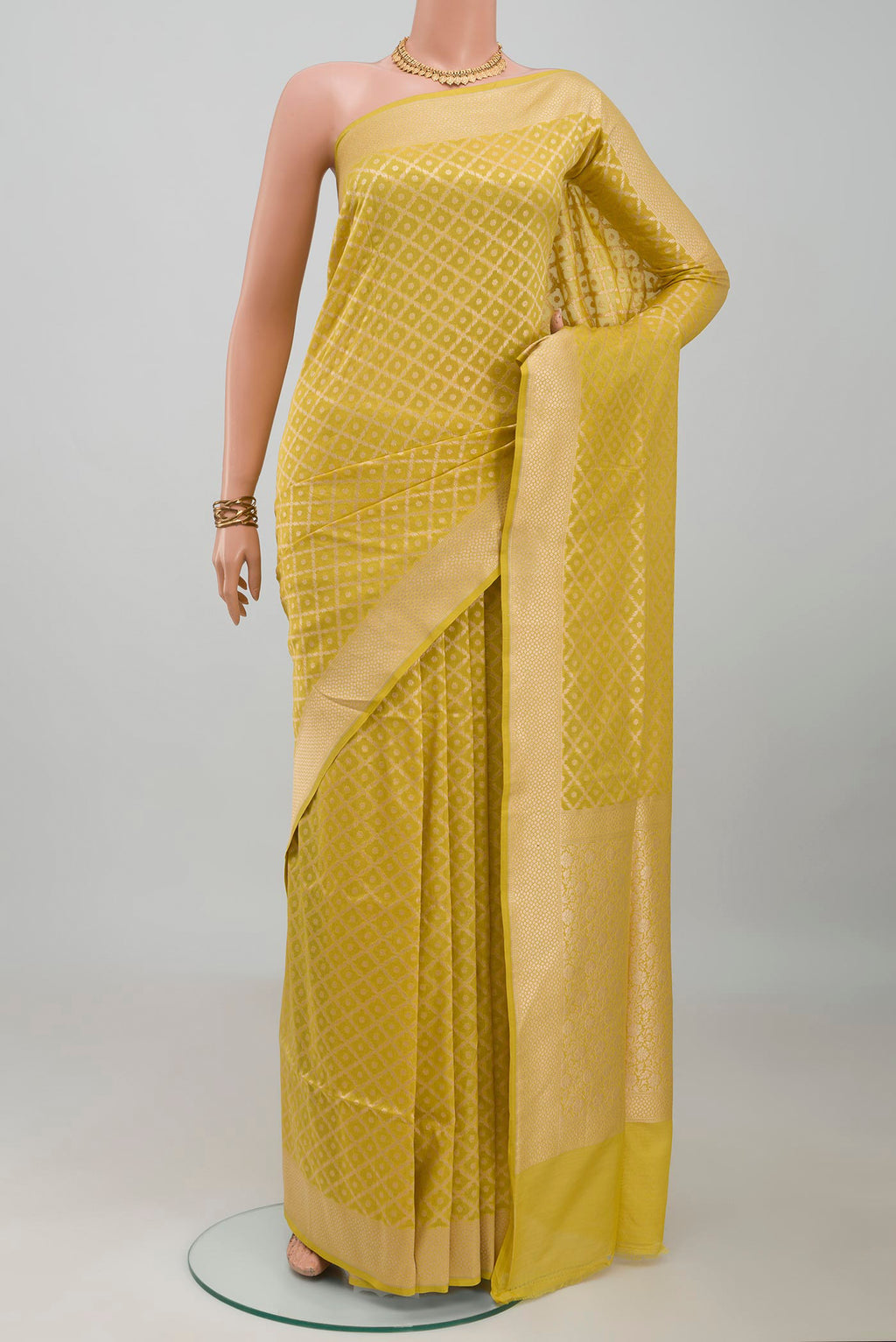 Mustard Banarasi Silk Saree with Zari Brocade on the body and Zari Border.  displayed on a mannequin