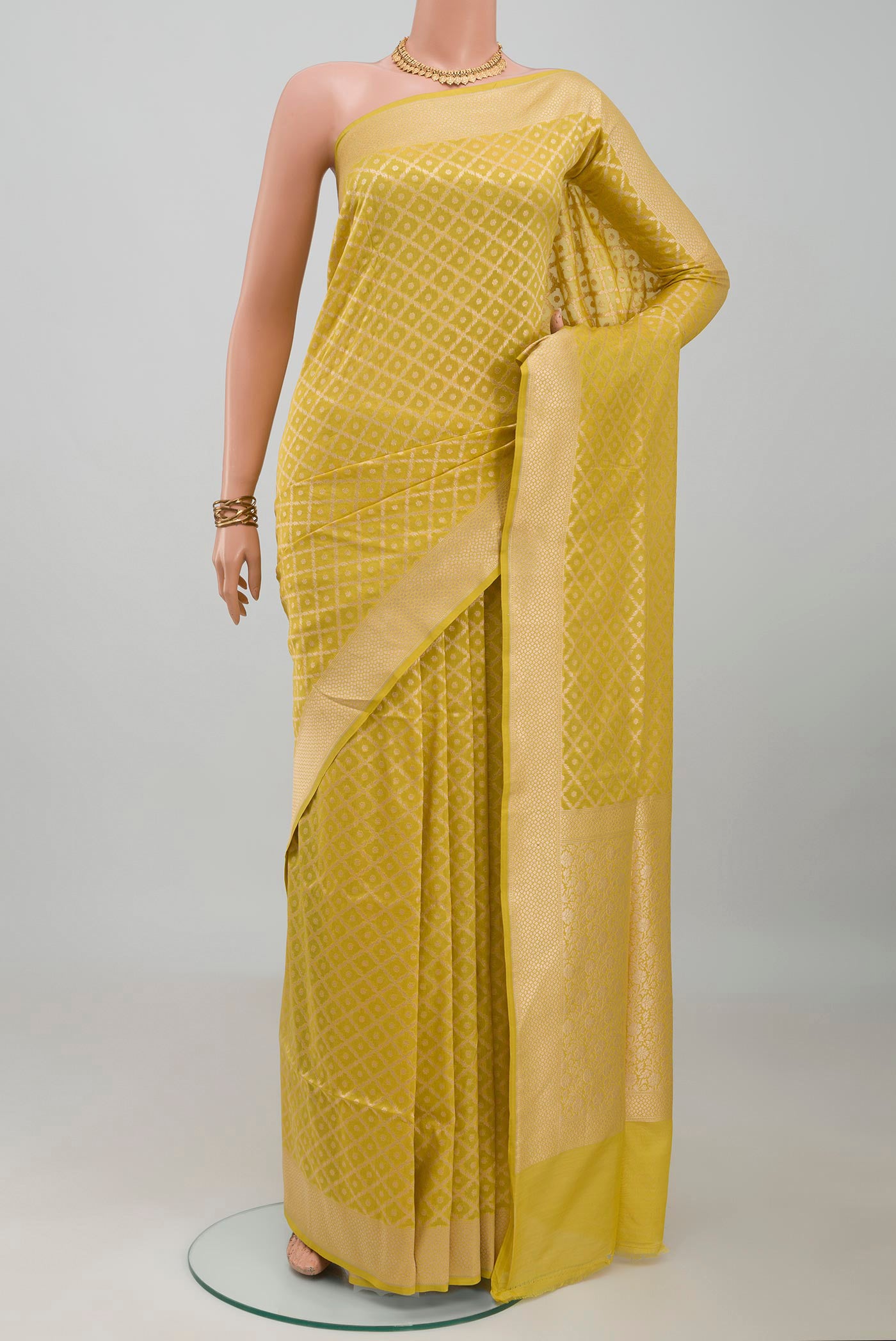Mustard Banarasi Silk Saree with Zari Brocade on the body and Zari Border.  displayed on a mannequin