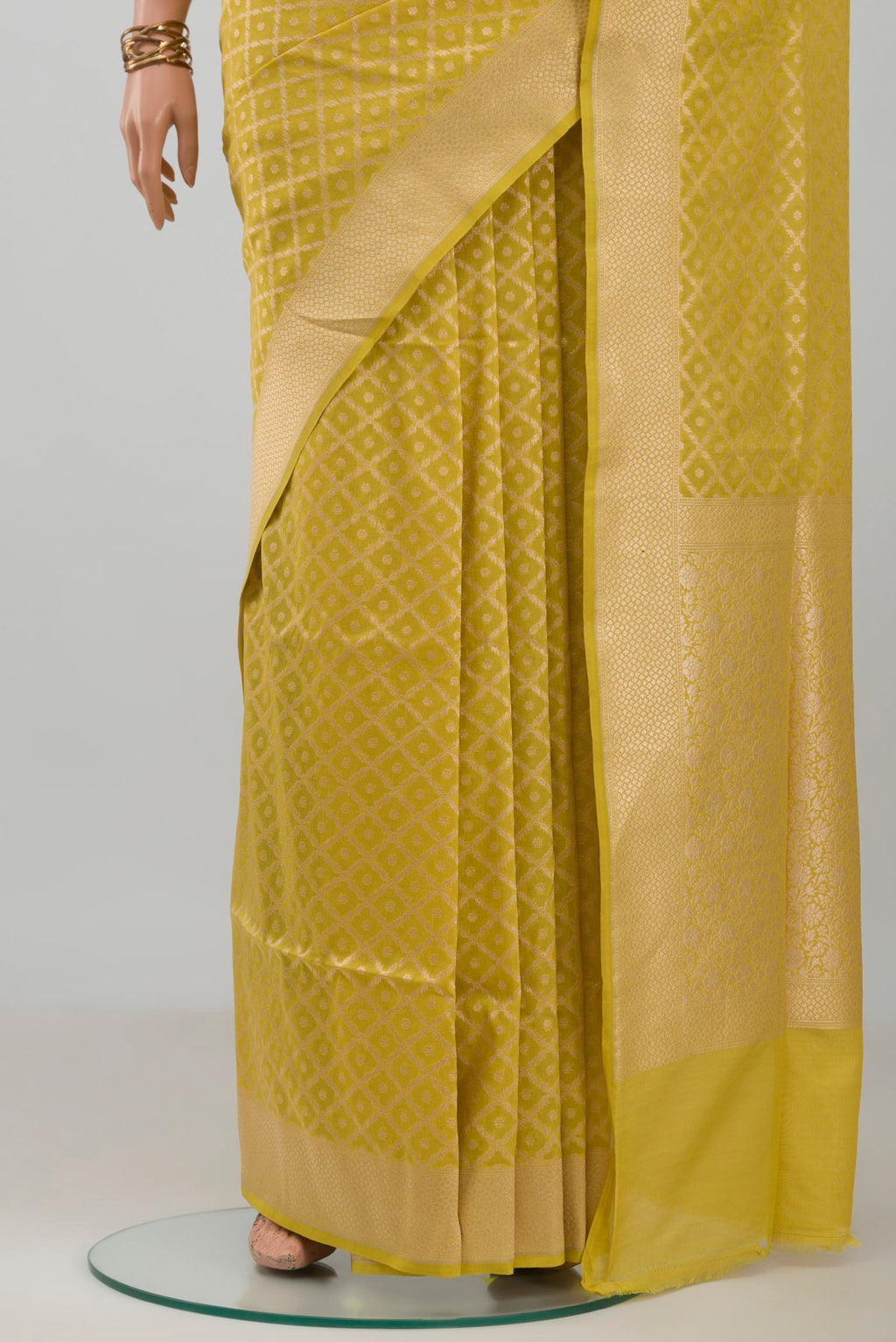 Pleats and pallu of Mustard Banarasi Silk Saree with Zari Brocade on the body and Zari Border. 