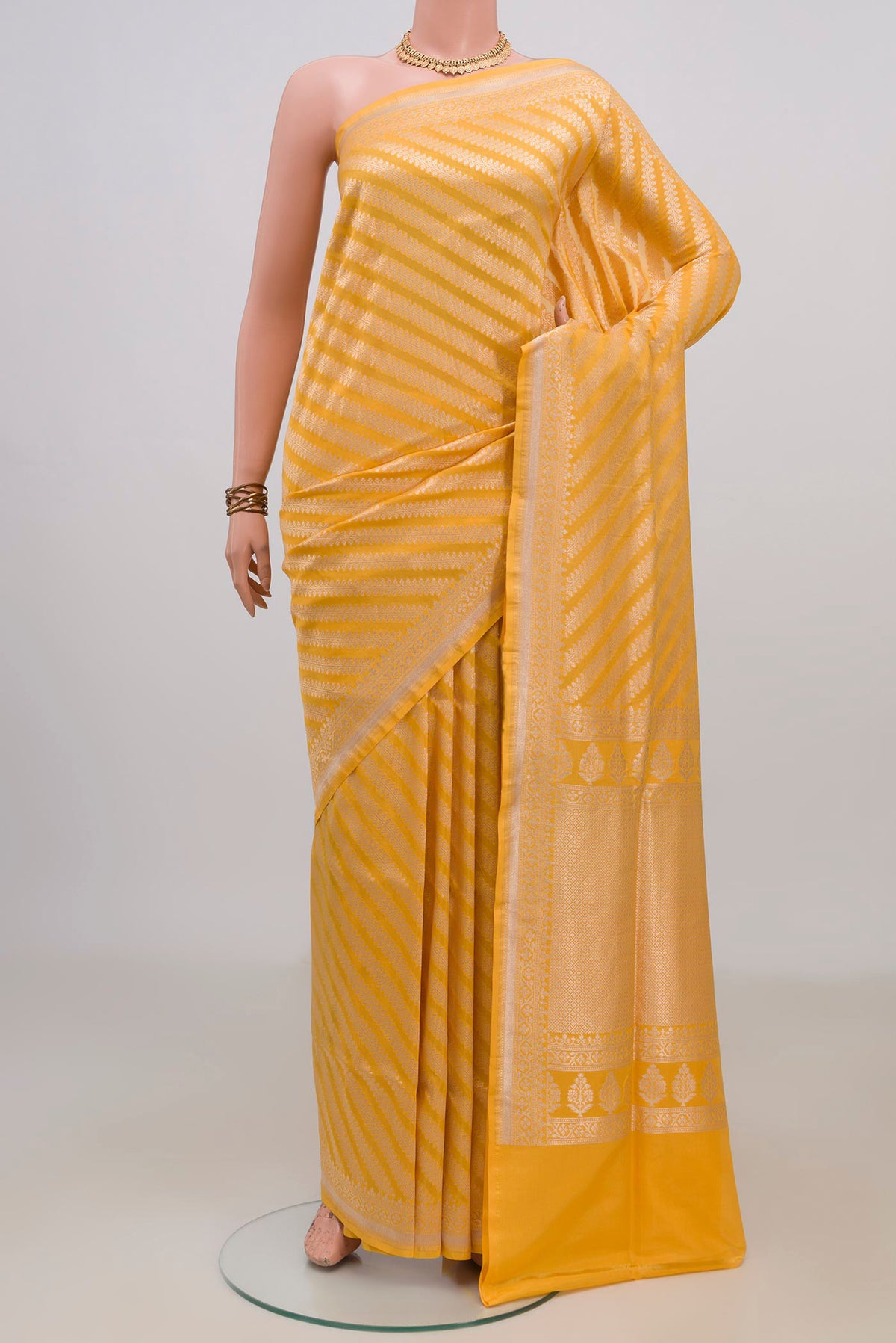 Pure Silk Yellow Banarasi Saree with Zari Brocade on the body and Fancy Border.  displayed on a mannequin