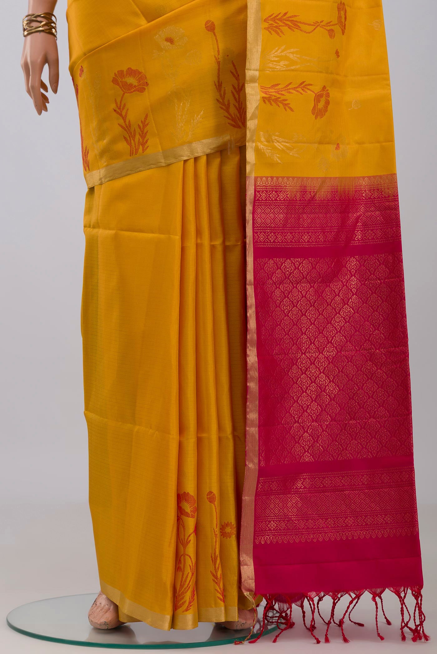 Pleats and pallu of Yellow Soft Silk Saree with Zari Butta on the body and Fancy Border. 