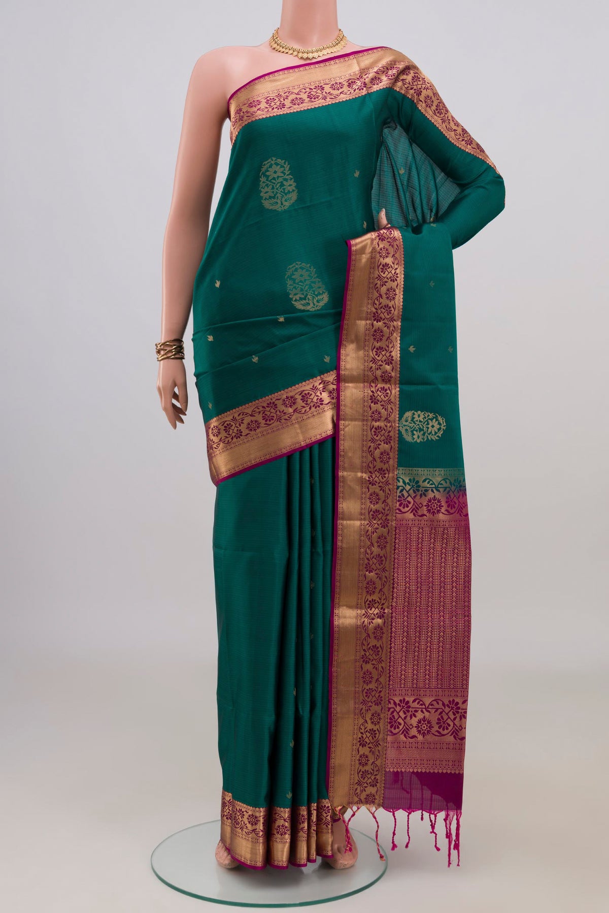 Pure Silk Green Soft Saree with Zari Butta on the body and Zari Border.  displayed on a mannequin
