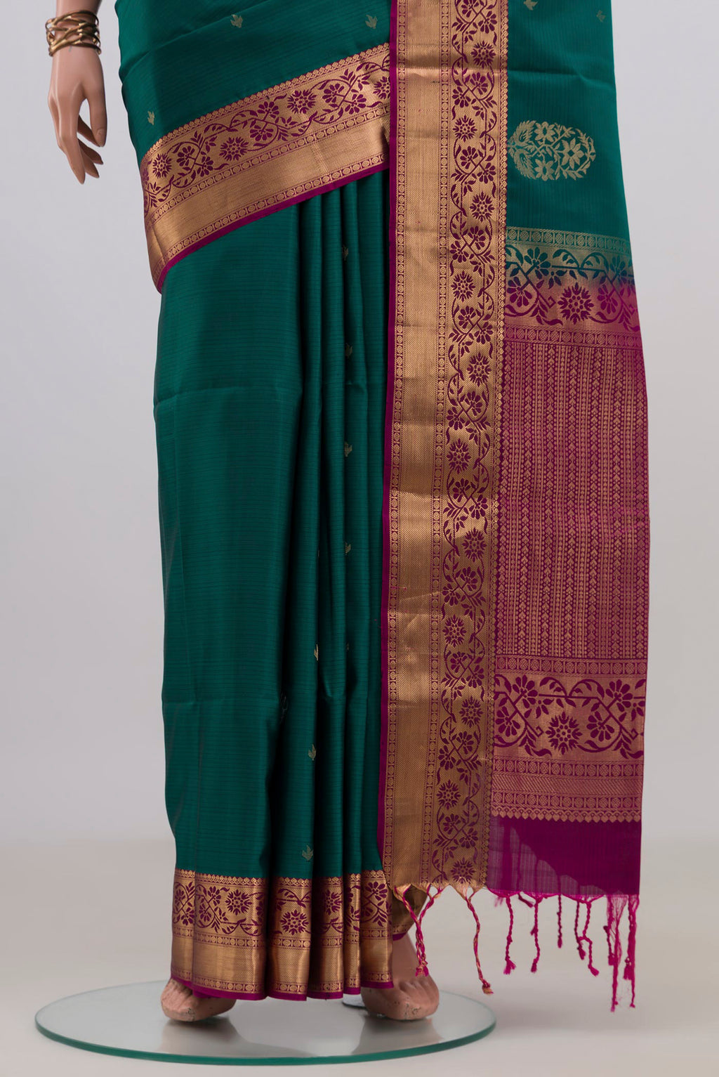 Pleats and pallu of Pure Silk Green Soft Saree with Zari Butta on the body and Zari Border. 