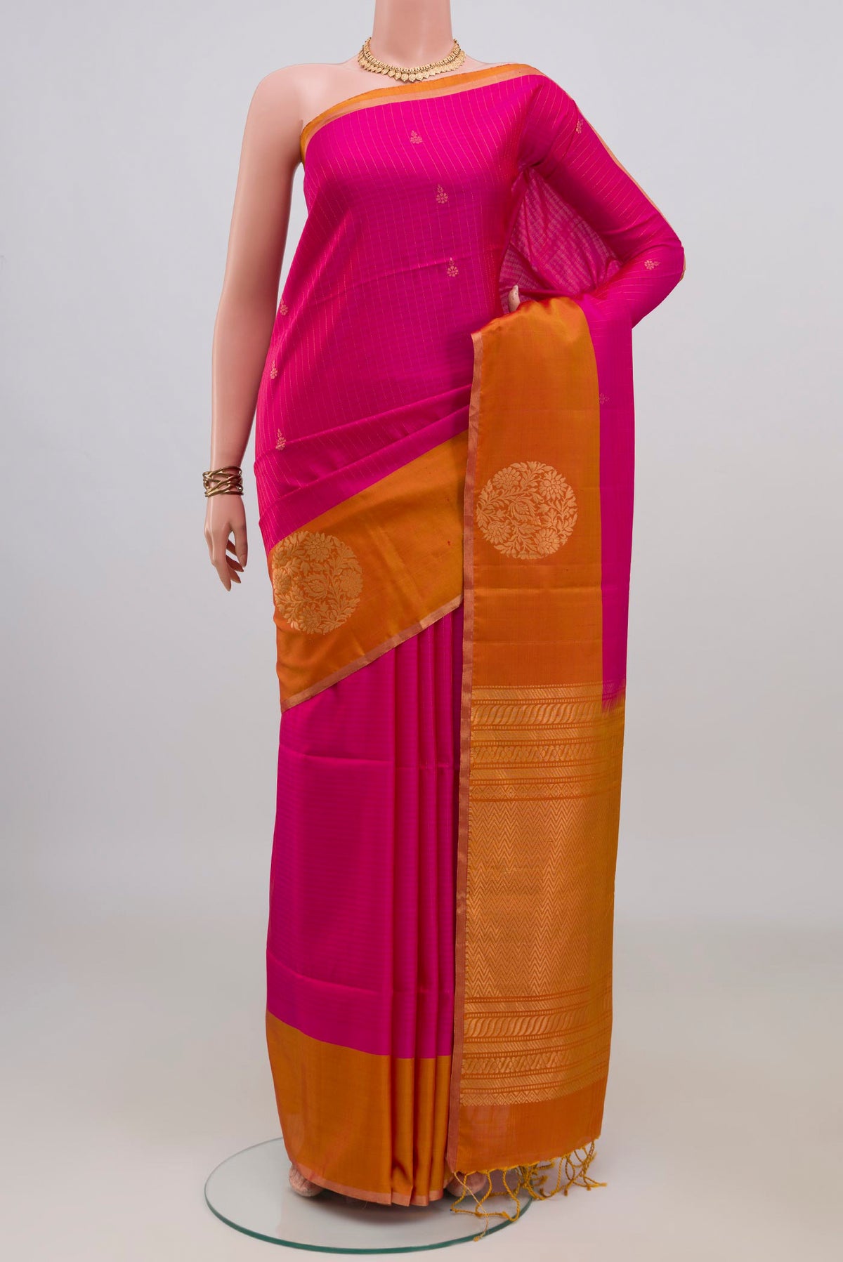 Pure Silk Pink Soft Saree with Zari Butta on the body and Fancy Border.  displayed on a mannequin