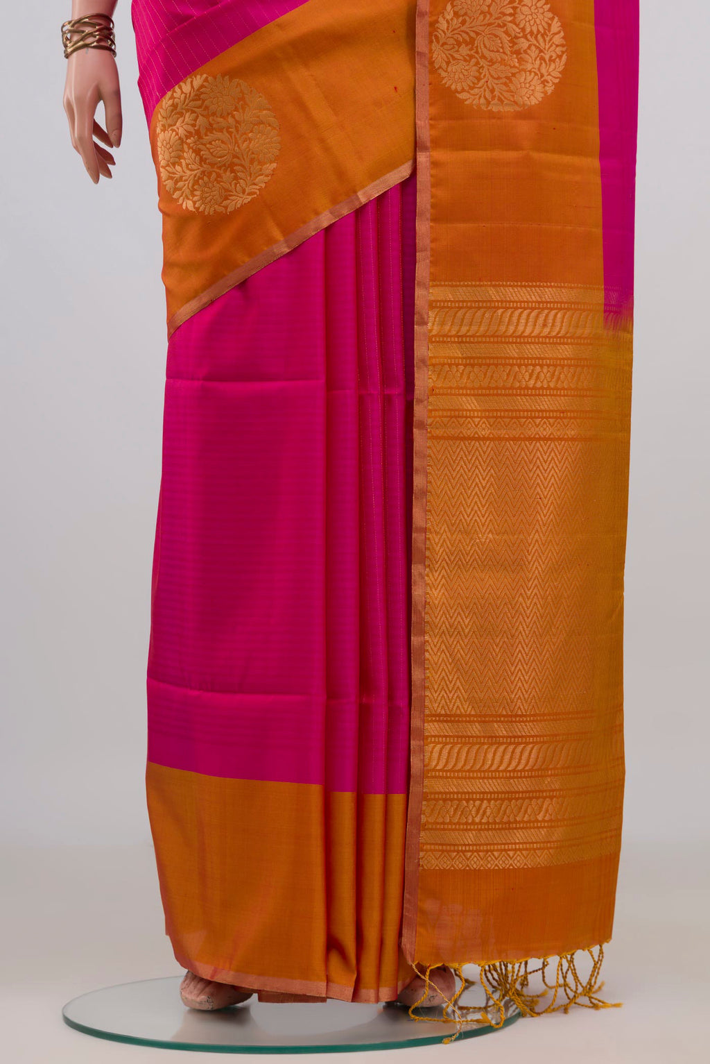 Pleats and pallu of Pure Silk Pink Soft Saree with Zari Butta on the body and Fancy Border. 