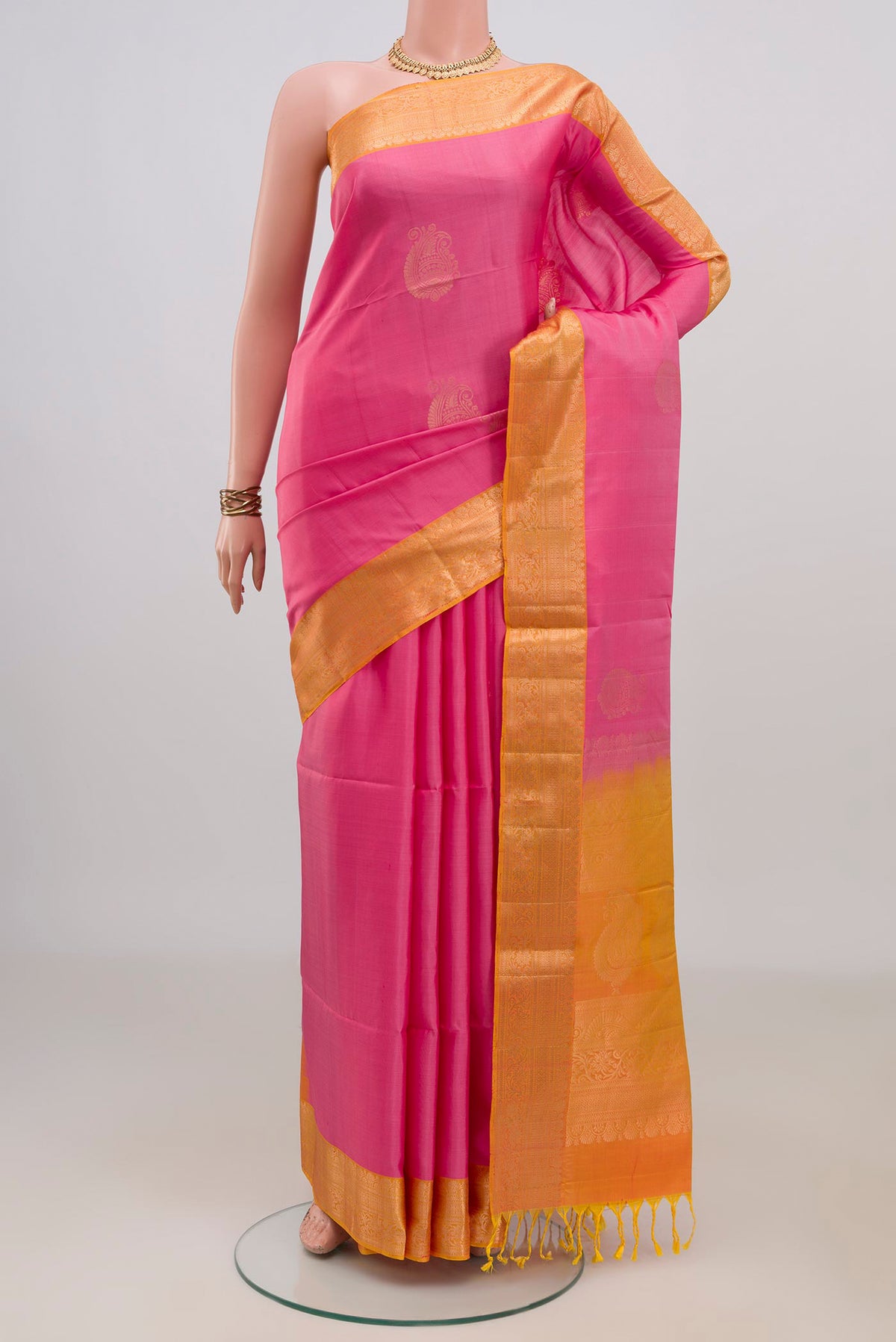 Pure Silk Pink Soft Saree with Zari Butta on the body and Zari Border.  displayed on a mannequin