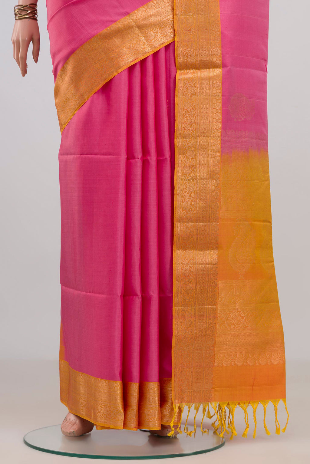 Pleats and pallu of Pure Silk Pink Soft Saree with Zari Butta on the body and Zari Border. 