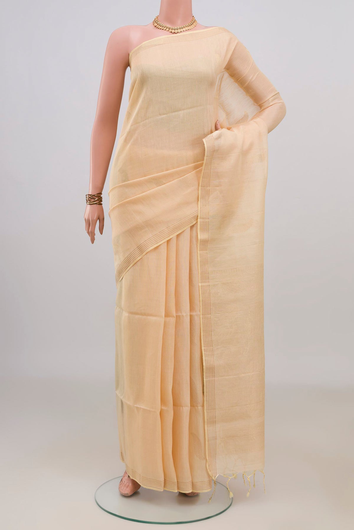 Pure Silk Sandal Soft Saree with Zari Butta on the body and Thin Zari Line.  displayed on a mannequin