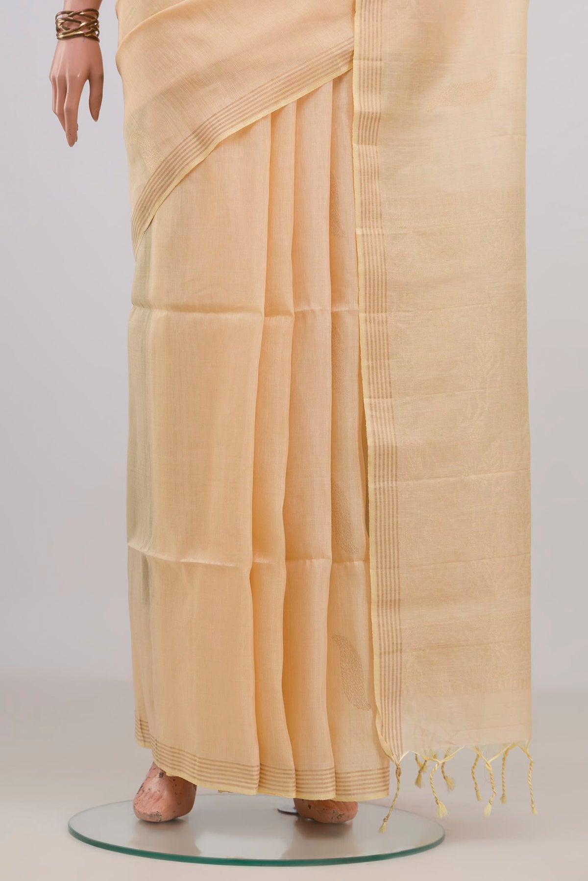 Pleats and pallu of Pure Silk Sandal Soft Saree with Zari Butta on the body and Thin Zari Line. 