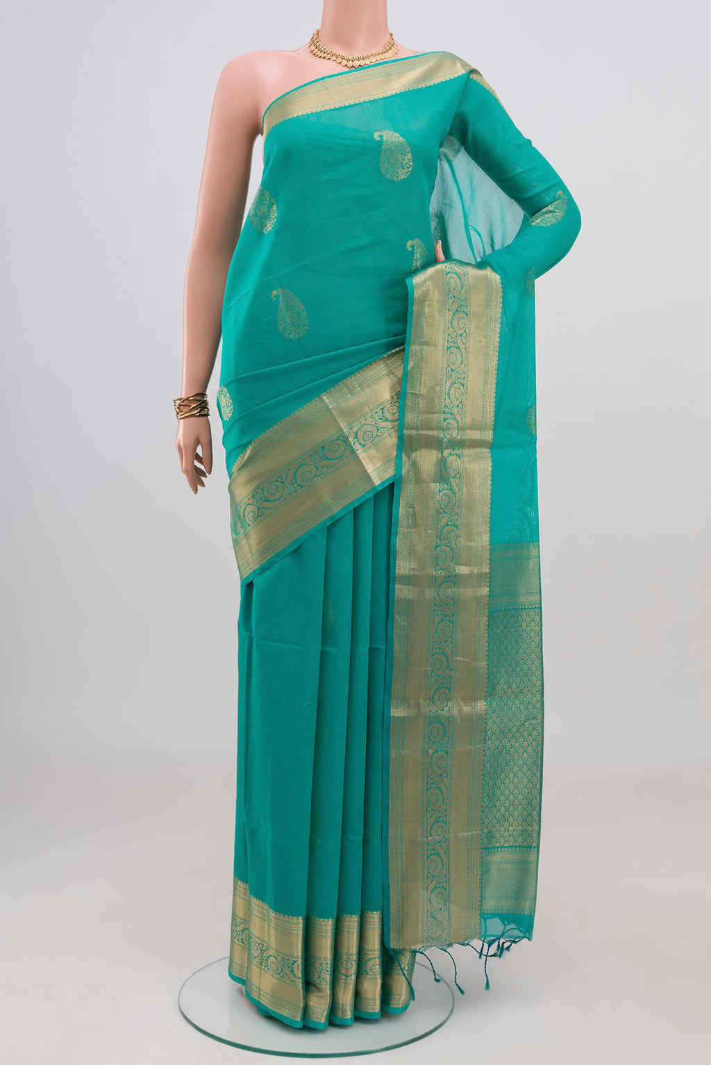 Turquoise Silk Cotton Saree with Zari Butta on the body and Zari Border.  displayed on a mannequin