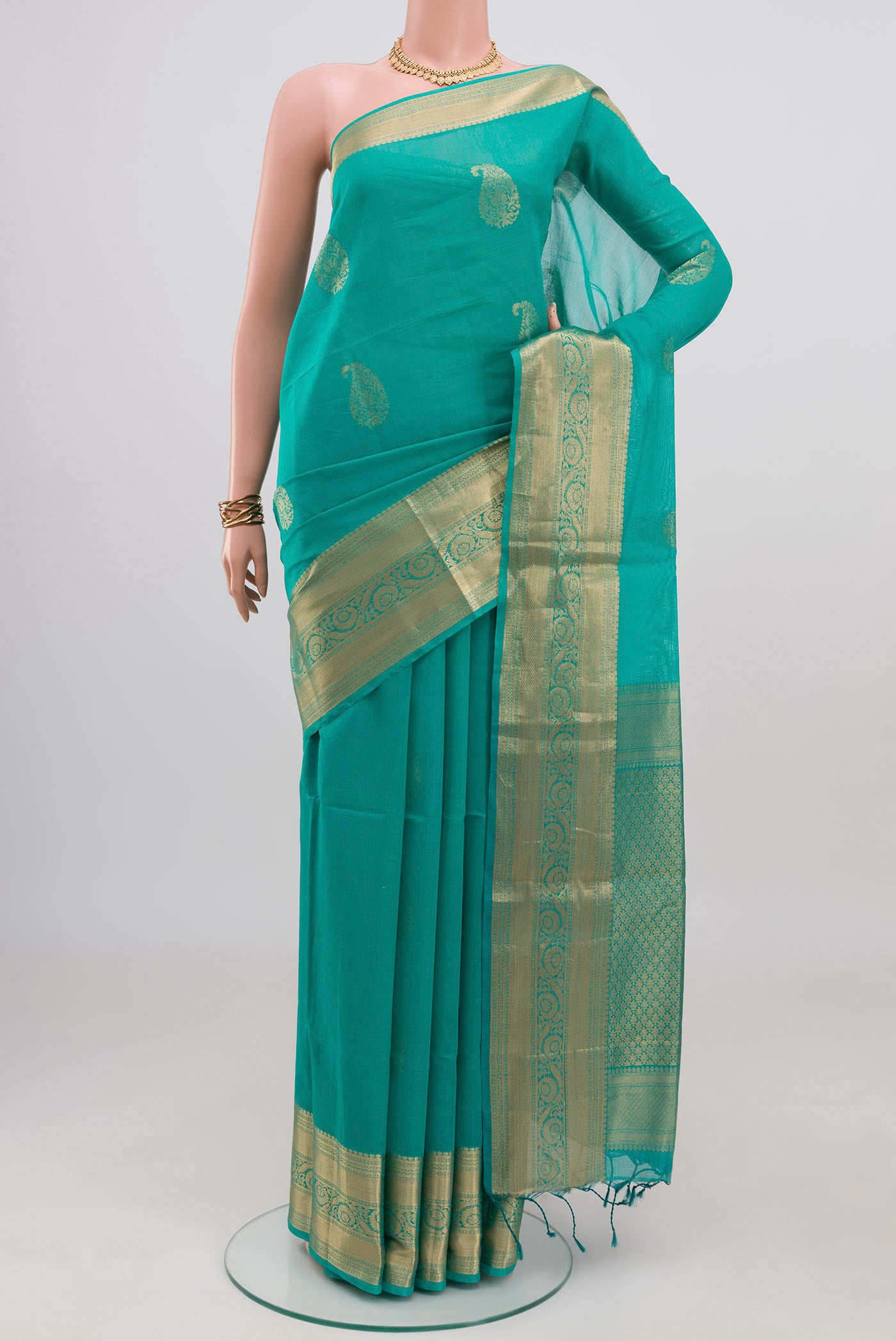 Turquoise Silk Cotton Saree with Zari Butta on the body and Zari Border.  displayed on a mannequin