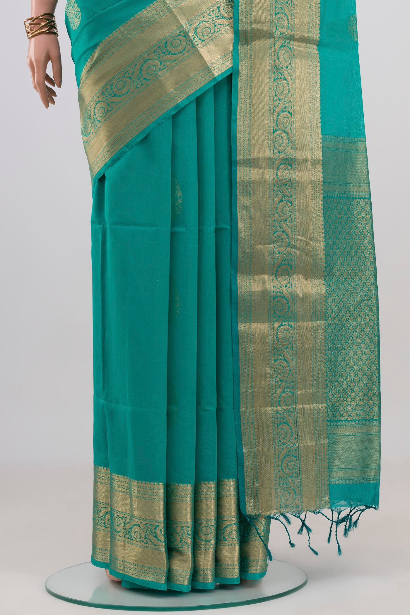 Pleats and pallu of Turquoise Silk Cotton Saree with Zari Butta on the body and Zari Border. 