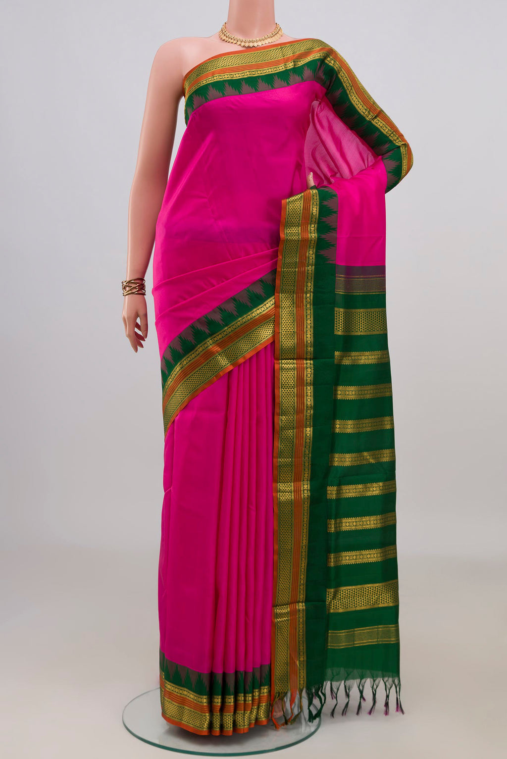 Pure Silk Rani Pink Kanjivaram Nine Yards Saree with Plain Body and Temple Border.  displayed on a mannequin