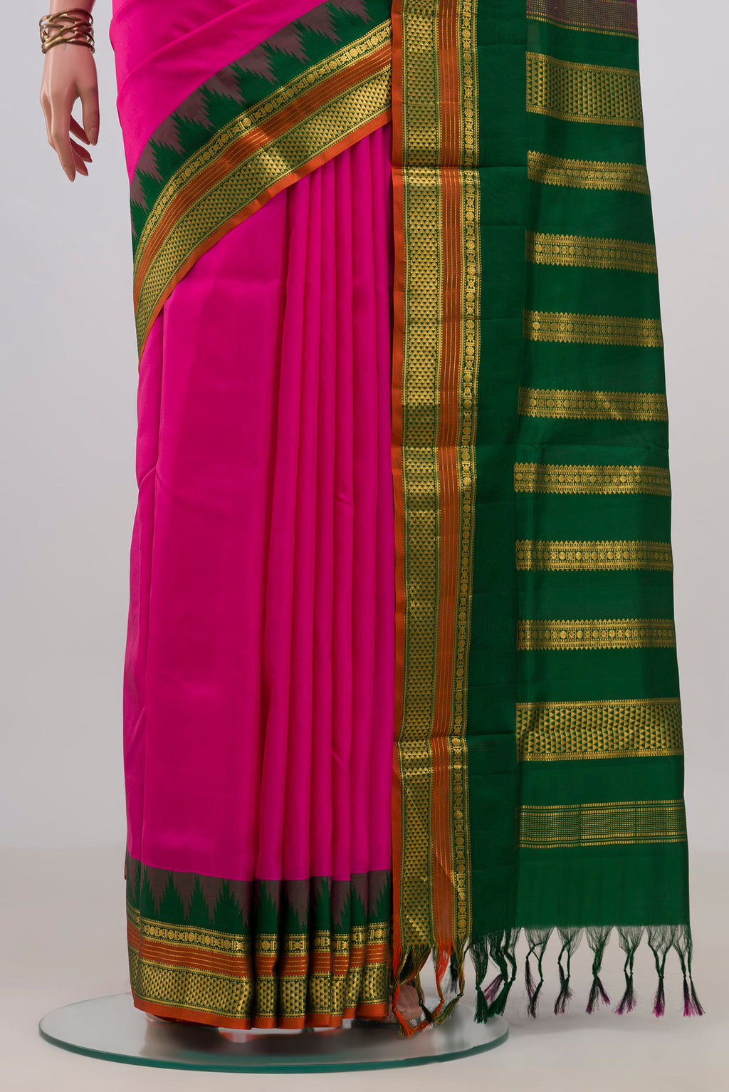 Pleats and pallu of Pure Silk Rani Pink Kanjivaram Nine Yards Saree with Plain Body and Temple Border. 