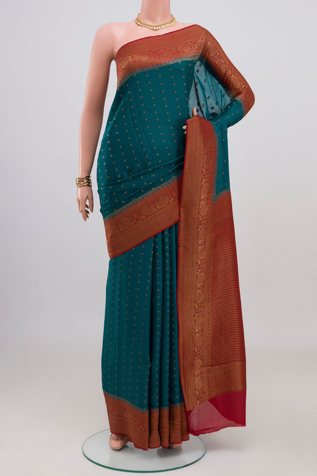 Teal Crepe Saree with Zari Butta on the body and Zari Border.  displayed on a mannequin