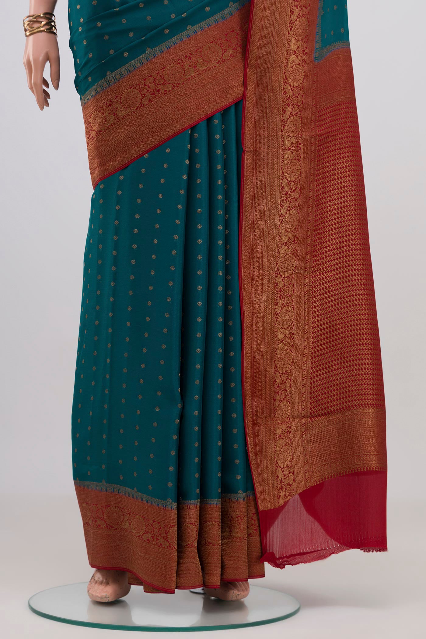Pleats and pallu of Teal Crepe Saree with Zari Butta on the body and Zari Border. 