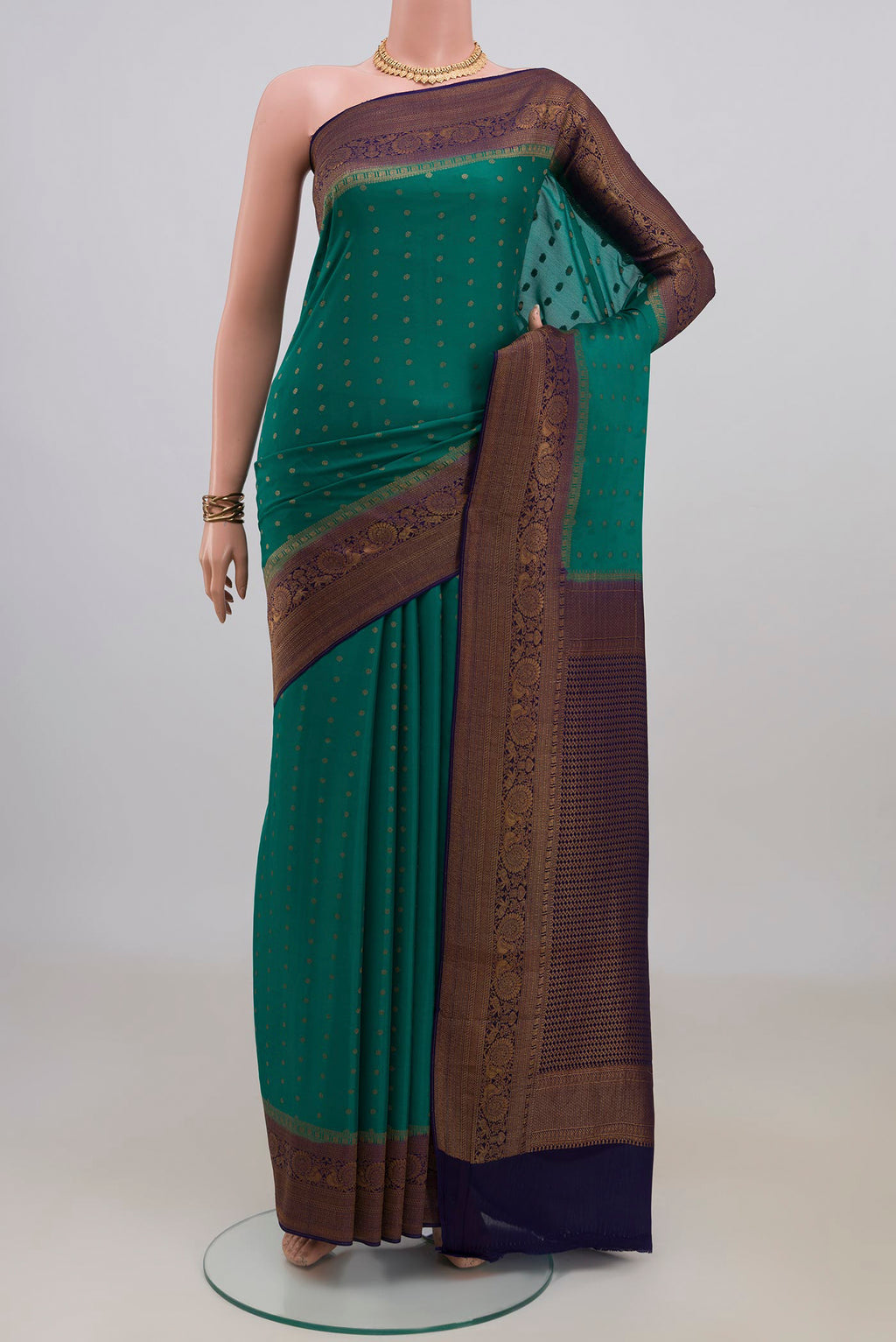 Pure Silk Green Mysore Crepe Saree with Zari Butta on the body and Zari Border.  displayed on a mannequin