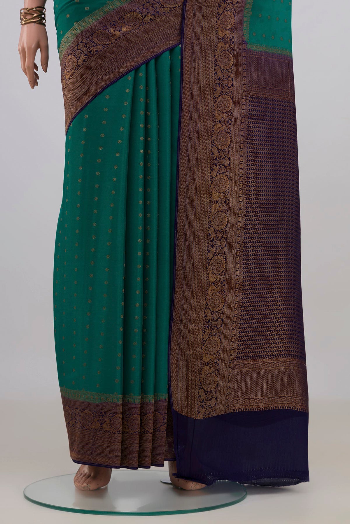 Pleats and pallu of Pure Silk Green Mysore Crepe Saree with Zari Butta on the body and Zari Border. 