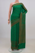 Green Crepe Saree with Zari Butta on the body and Fancy Border.  displayed on a mannequin