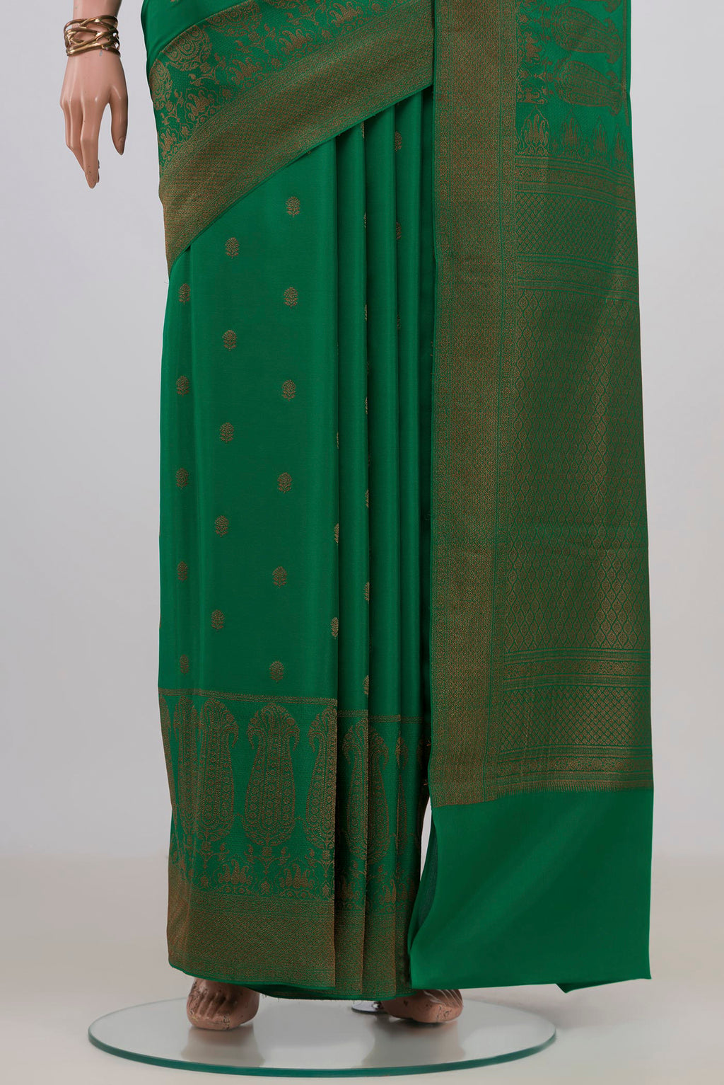 Pleats and pallu of Green Crepe Saree with Zari Butta on the body and Fancy Border. 