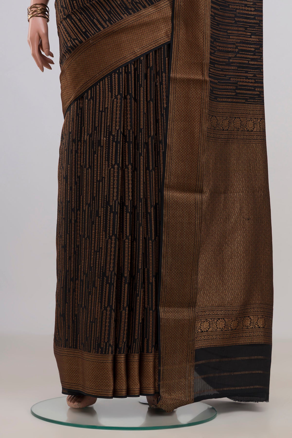 Pleats and pallu of Black Mysore Crepe Saree with Stripes on the body and Zari Border. 