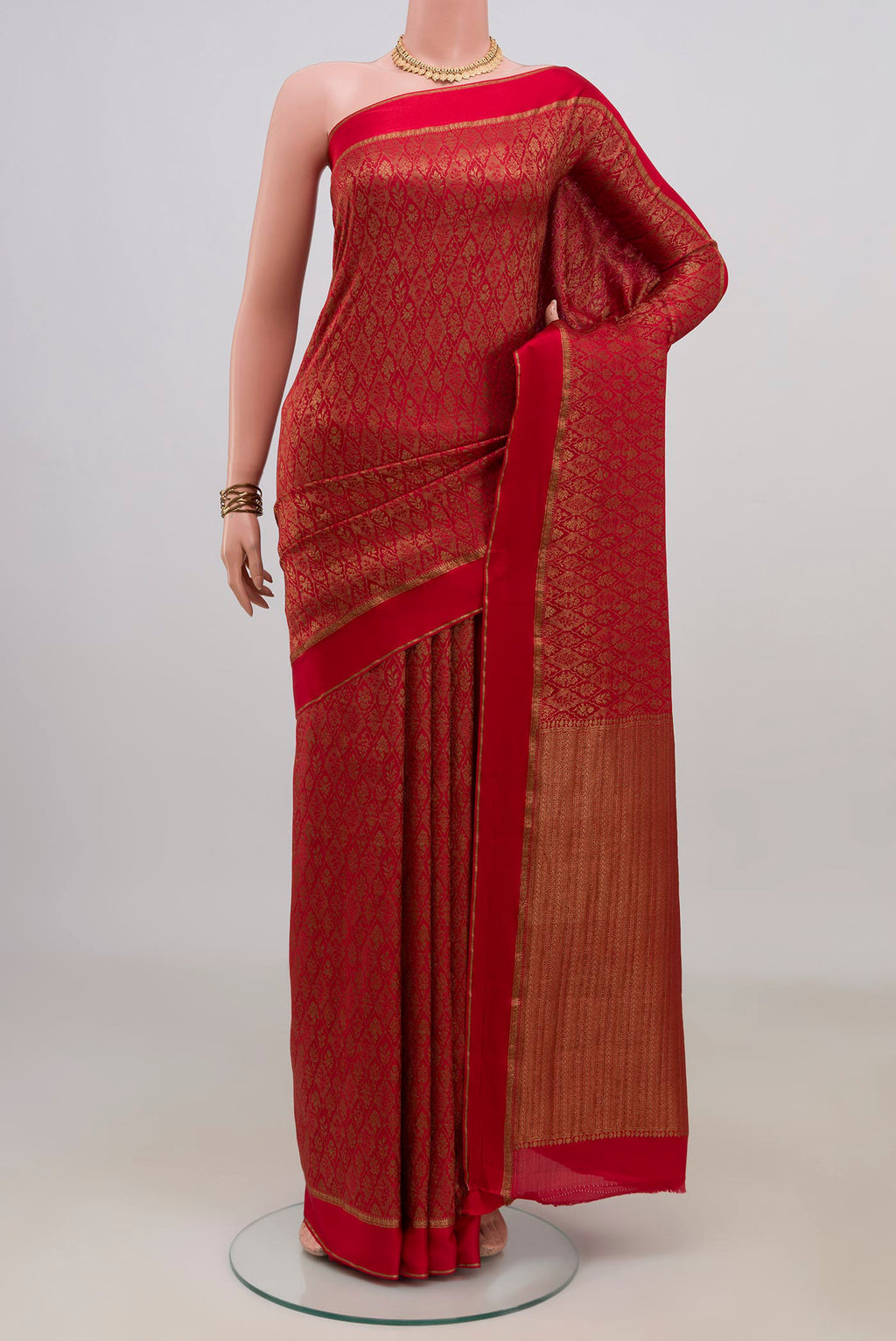 Red Crepe Saree with Zari Brocade on the body and Thin Zari Line.  displayed on a mannequin