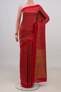 Red Crepe Saree with Zari Brocade on the body and Thin Zari Line.  displayed on a mannequin