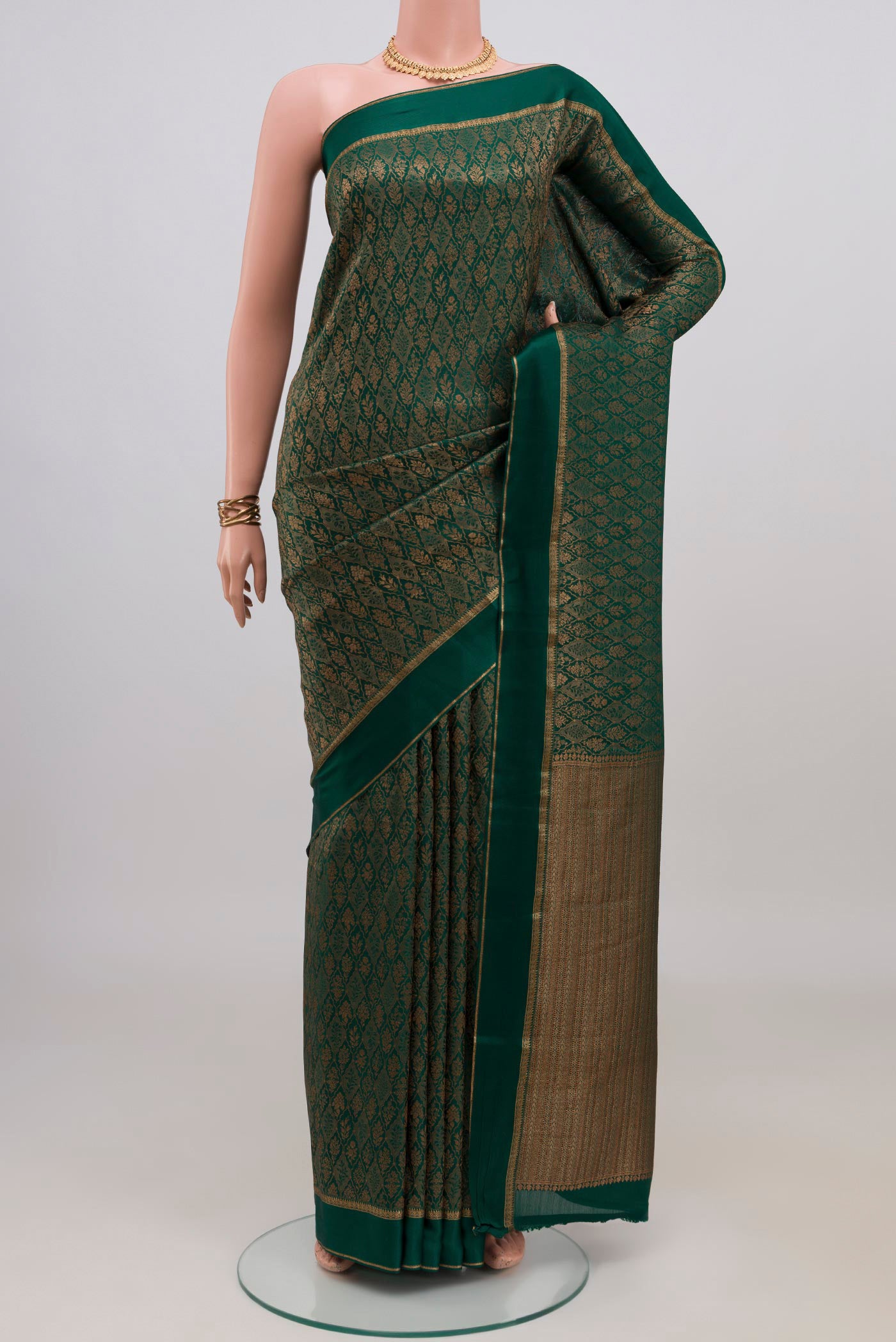 Bottle Green Mysore Crepe Saree with Zari Brocade on the body and Thin Zari Line.  displayed on a mannequin