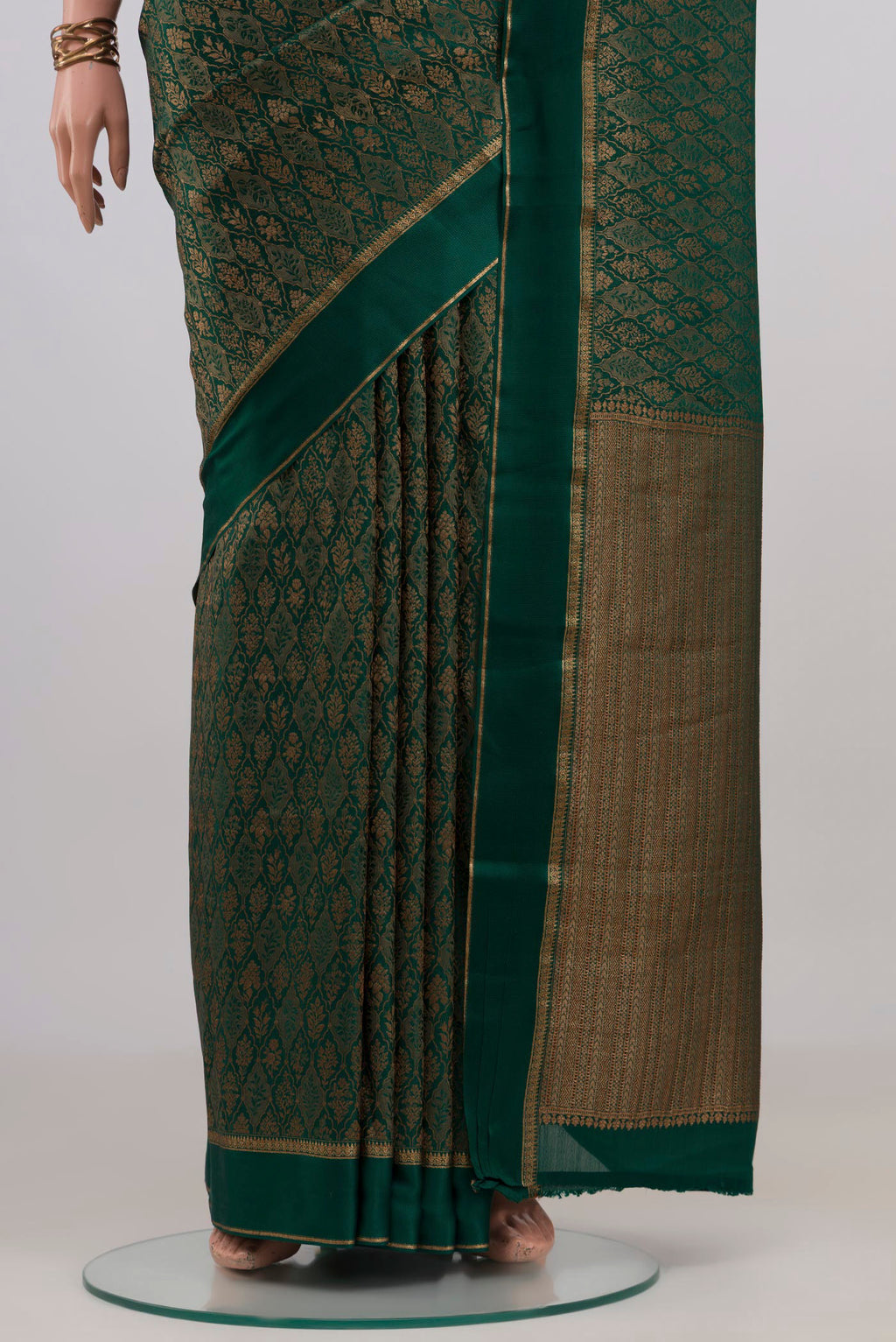 Pleats and pallu of Bottle Green Mysore Crepe Saree with Zari Brocade on the body and Thin Zari Line. 
