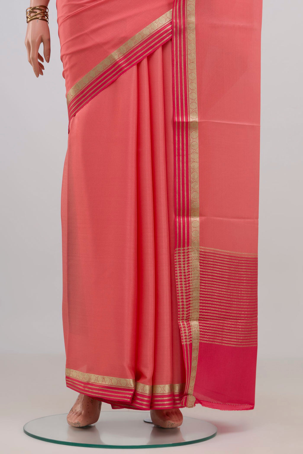 Pleats and pallu of Peach Mysore Crepe Saree with Plain Body and Thin Zari Line. 