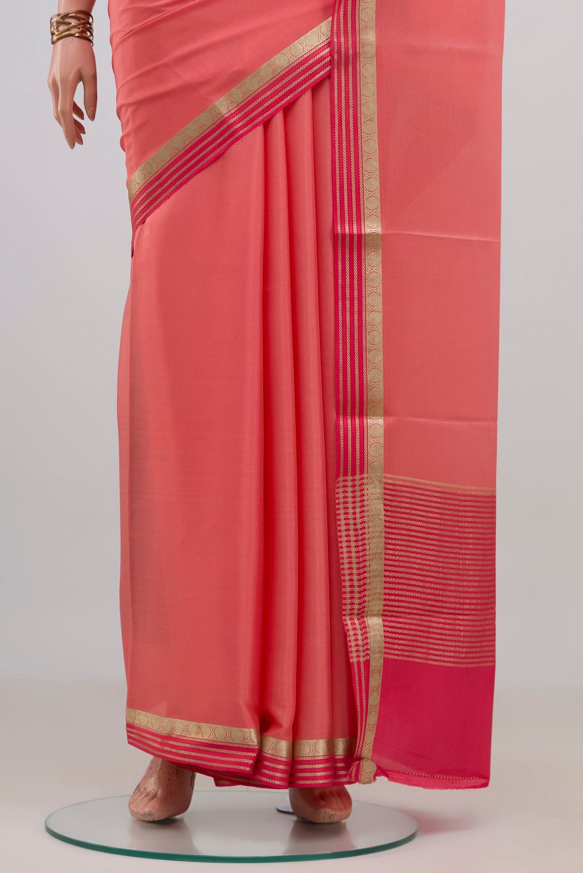 Pleats and pallu of Peach Mysore Crepe Saree with Plain Body and Thin Zari Line. 