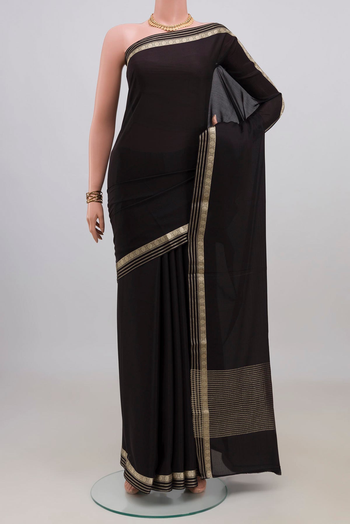 Black Mysore Crepe Saree with Plain Body and Zari Border.  displayed on a mannequin