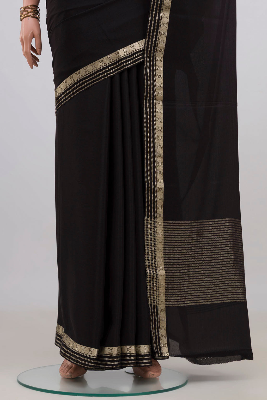 Pleats and pallu of Black Mysore Crepe Saree with Plain Body and Zari Border. 