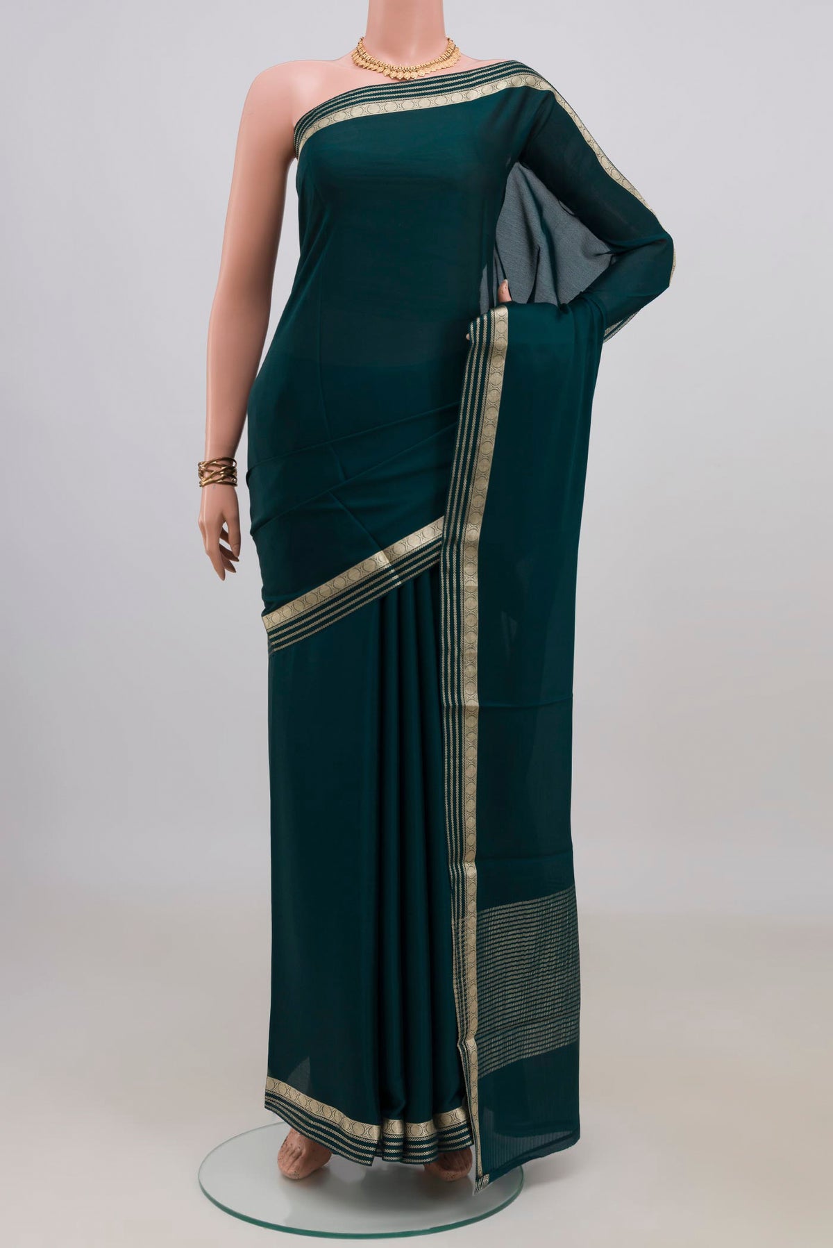 Green Mysore Crepe Saree with Plain Body and Zari Border.  displayed on a mannequin