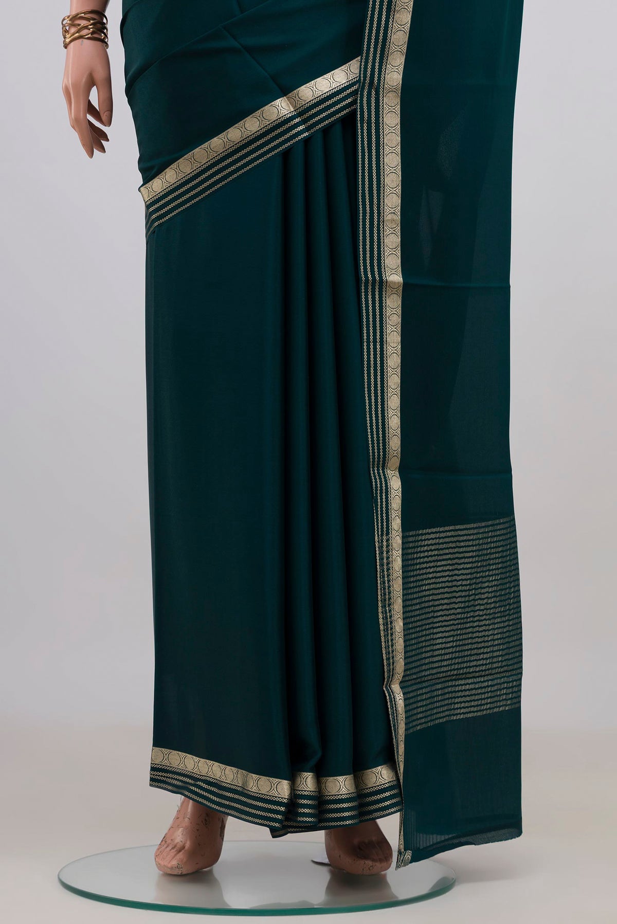 Pleats and pallu of Green Mysore Crepe Saree with Plain Body and Zari Border. 