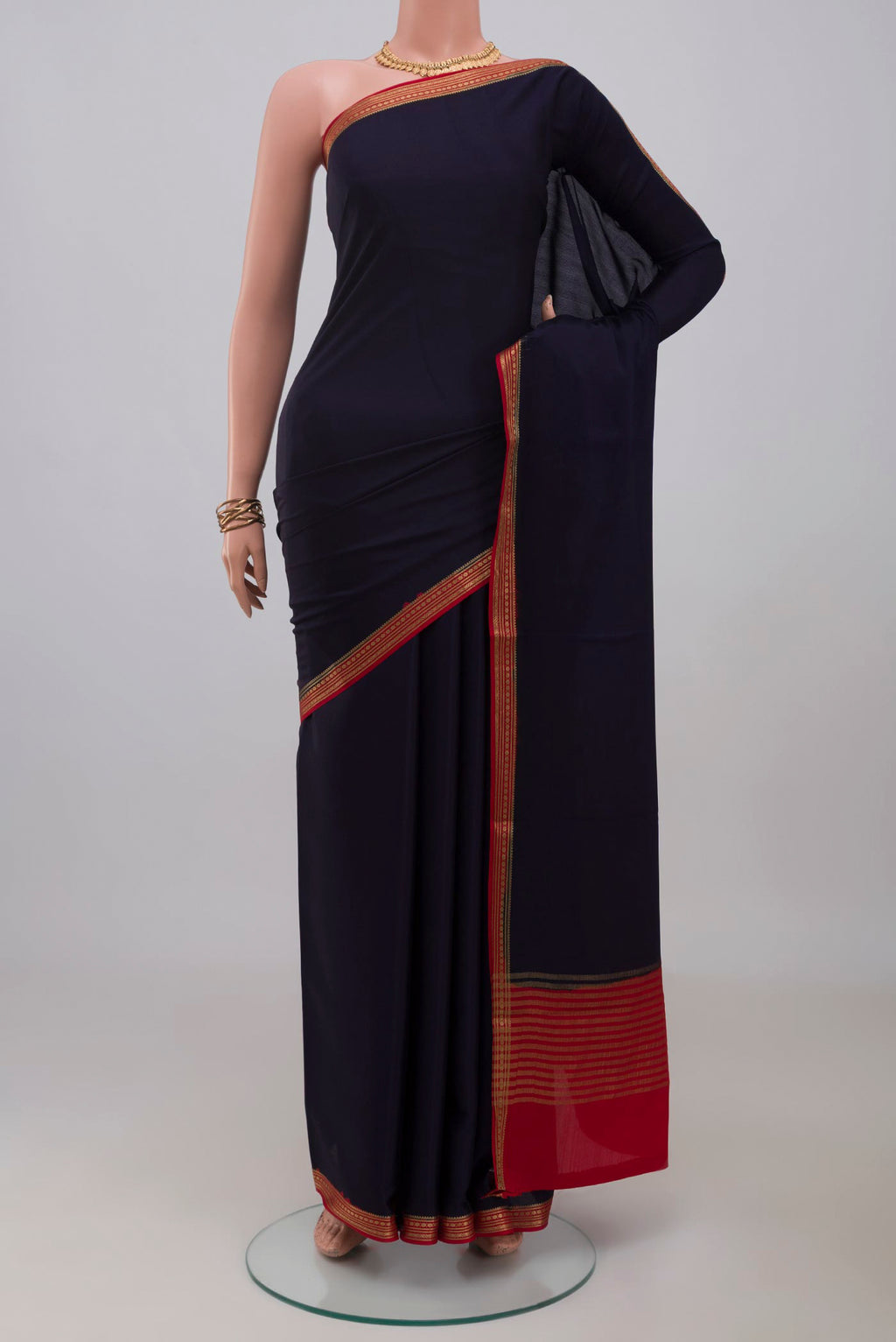 Navy Blue Mysore Crepe Saree with Plain Body and Zari Border.  displayed on a mannequin
