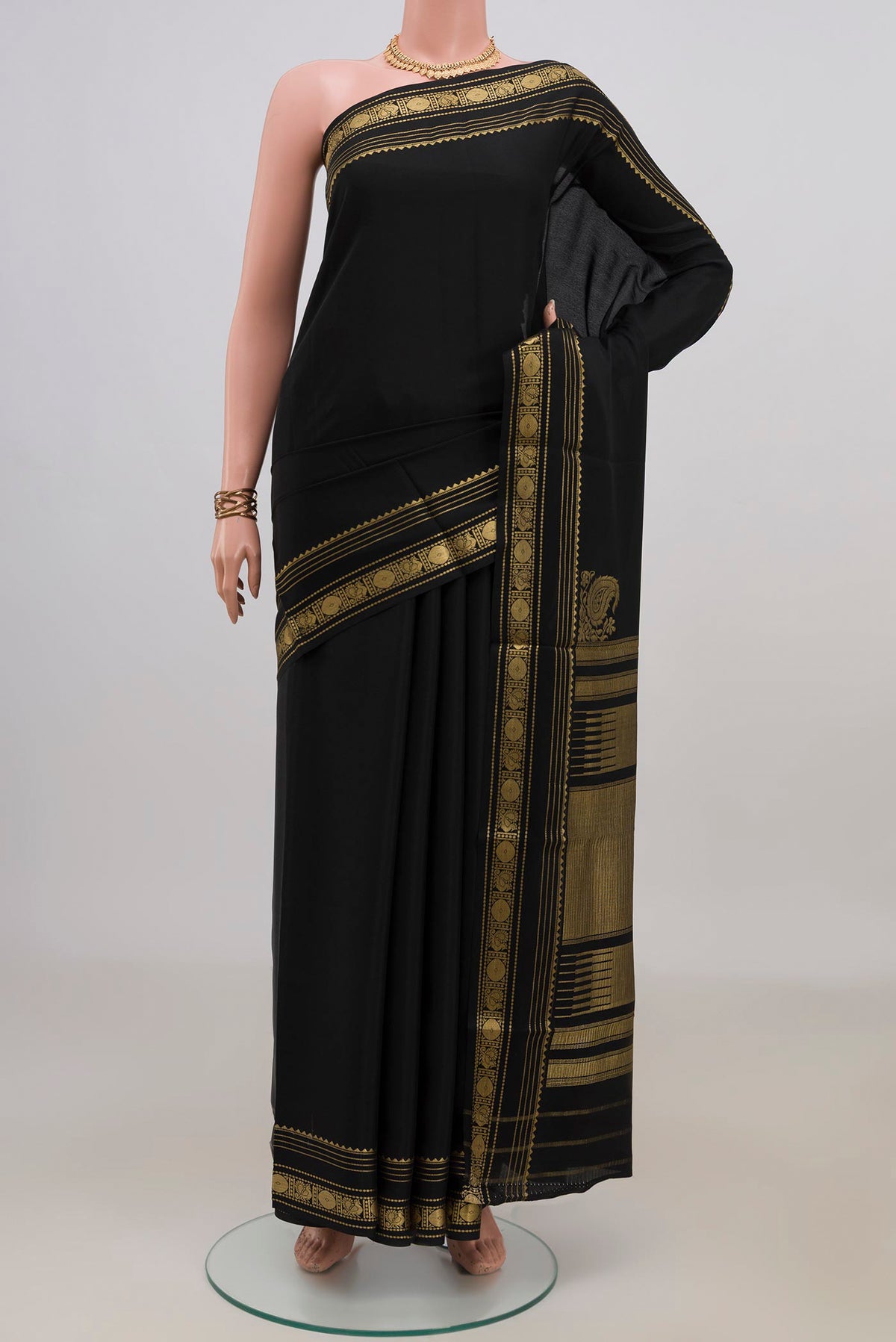 Black Crepe Saree with Plain Body and Zari Border.  displayed on a mannequin