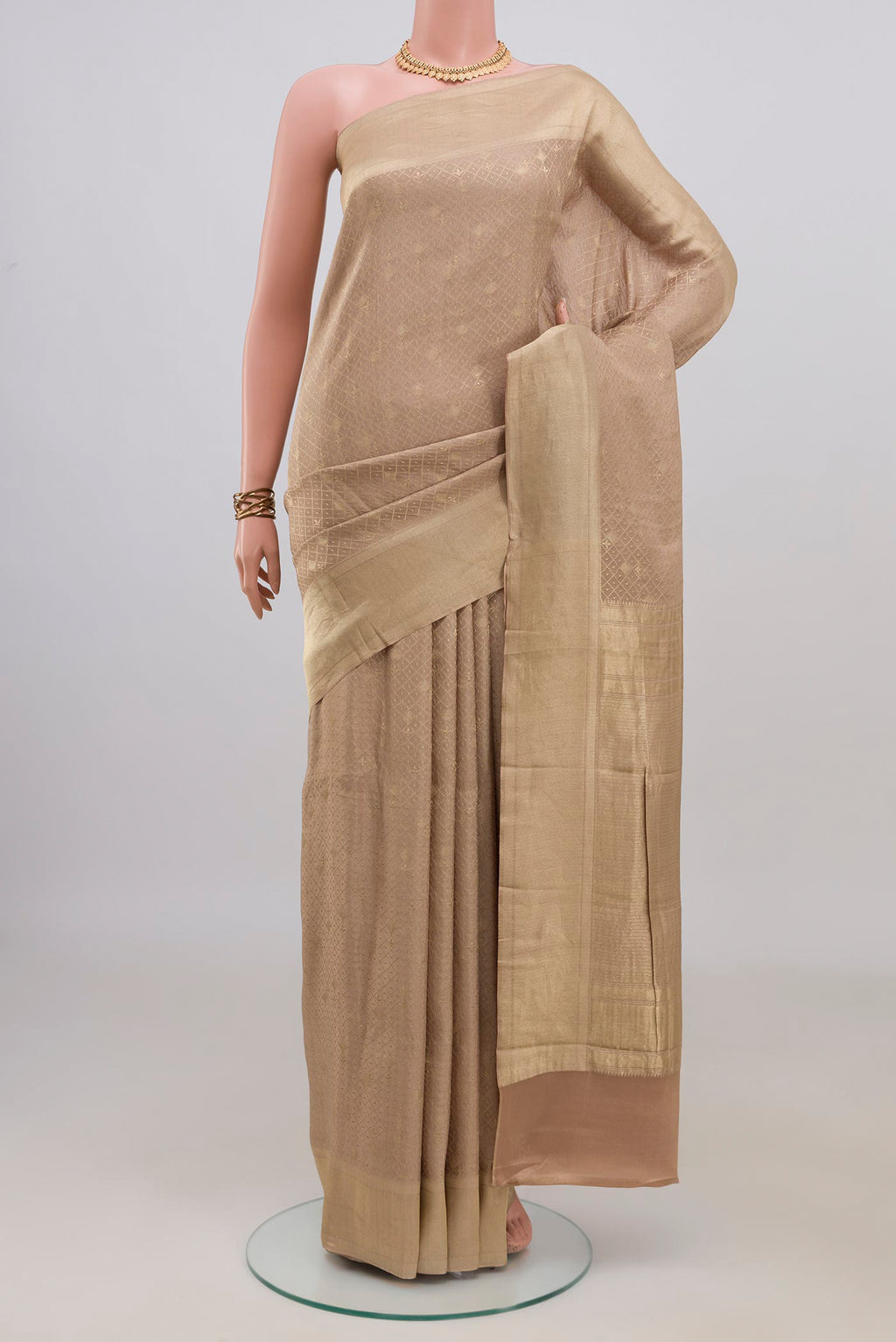 Beige Mysore Crepe Saree with Zari Brocade on the body and Zari Border.  displayed on a mannequin