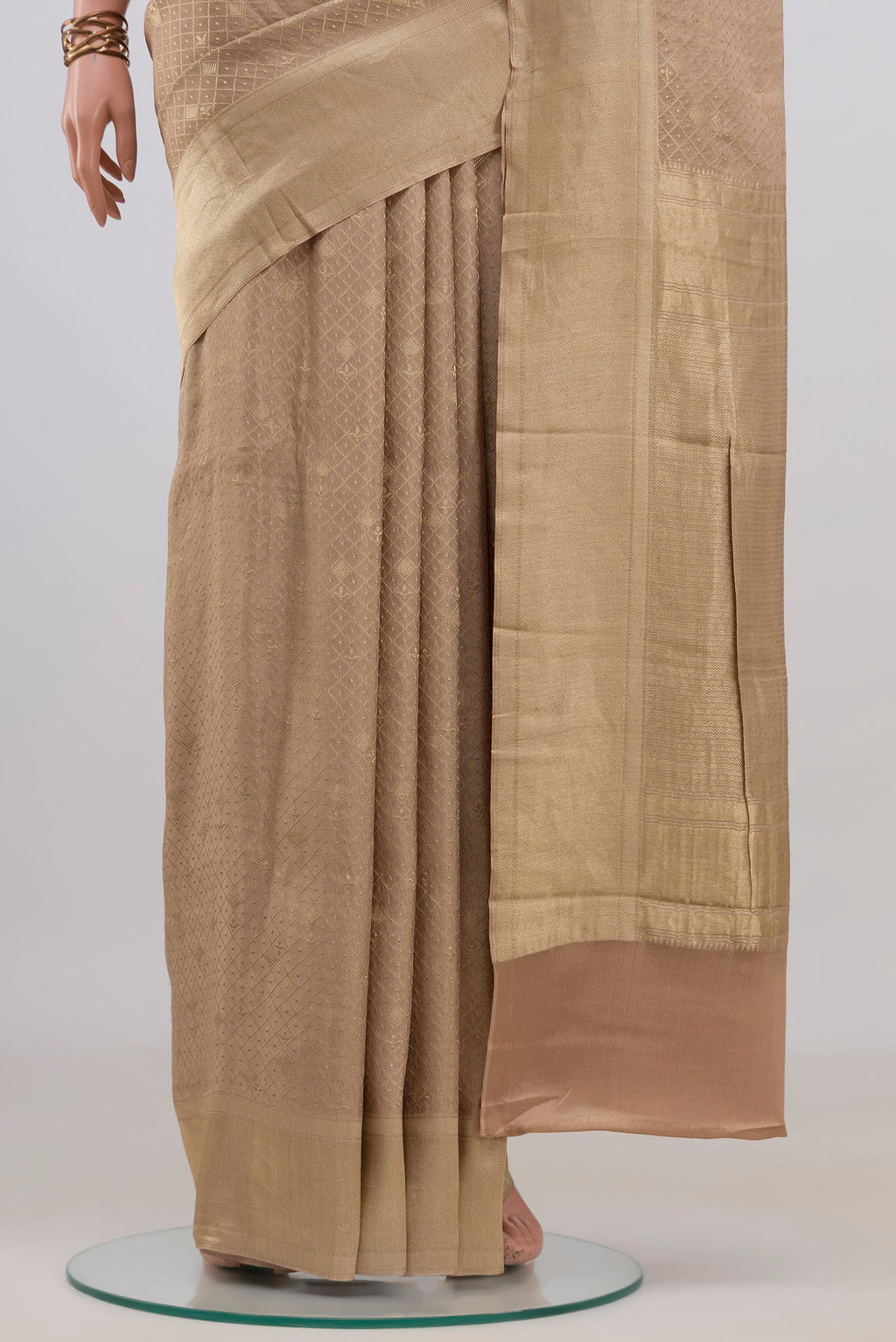 Pleats and pallu of Beige Mysore Crepe Saree with Zari Brocade on the body and Zari Border. 