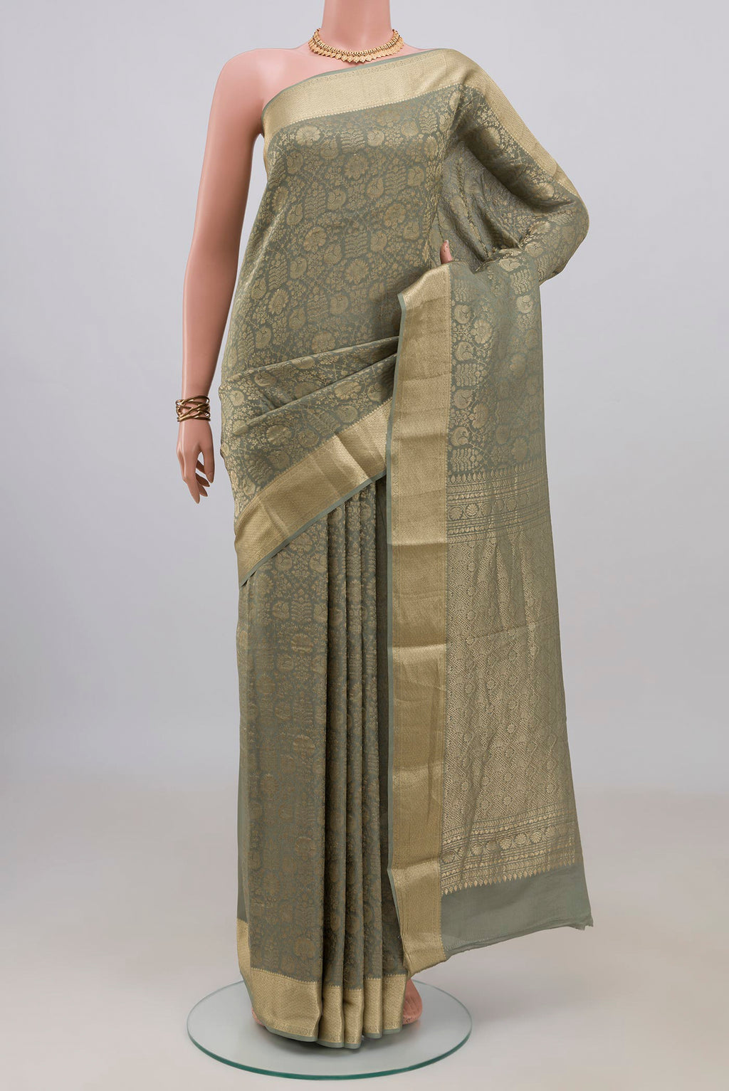 Sage Green Mysore Crepe Saree with Zari Brocade on the body and Zari Border.  displayed on a mannequin