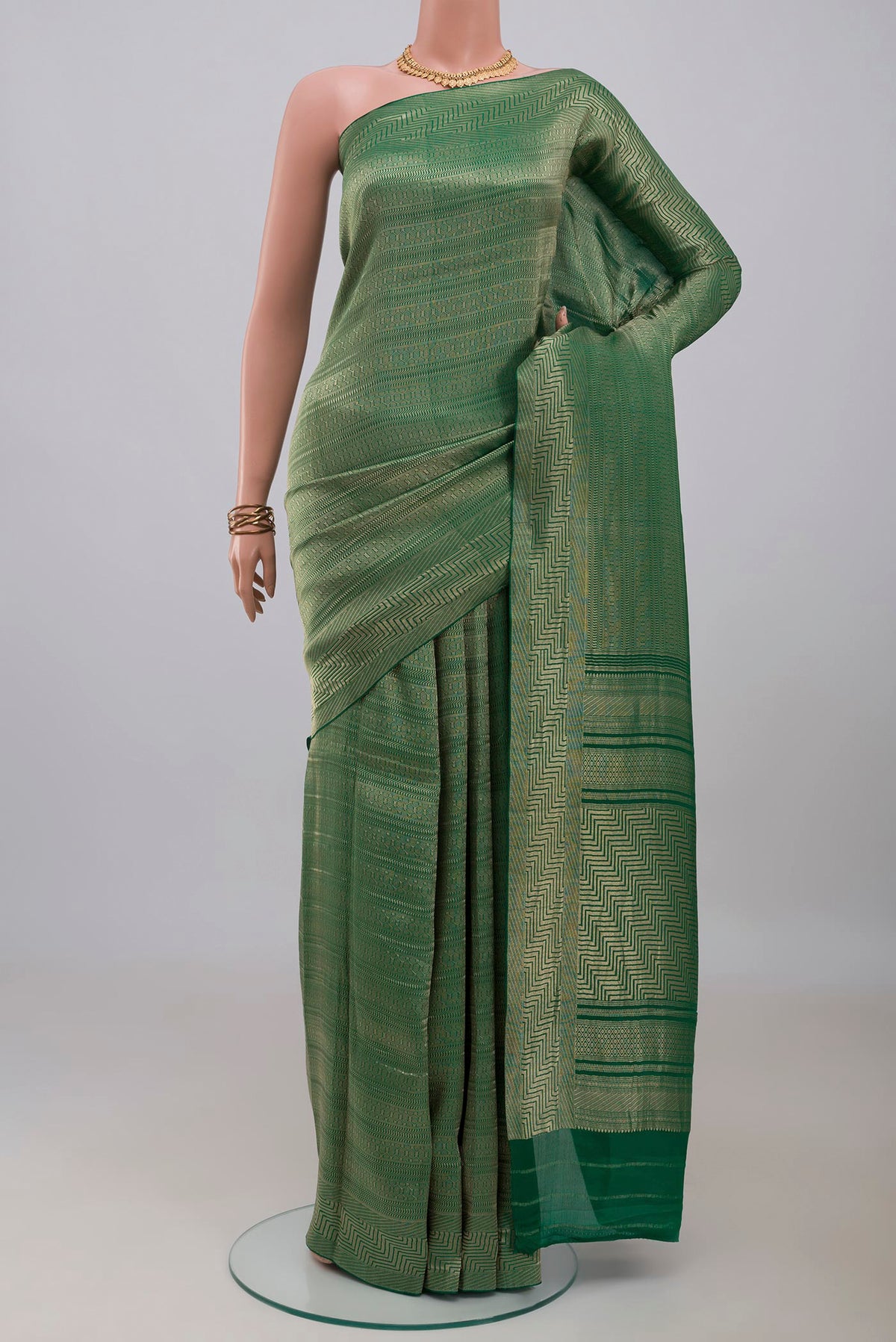 Green Banarasi Silk Saree with Zari Brocade on the body and Zari Border.  displayed on a mannequin
