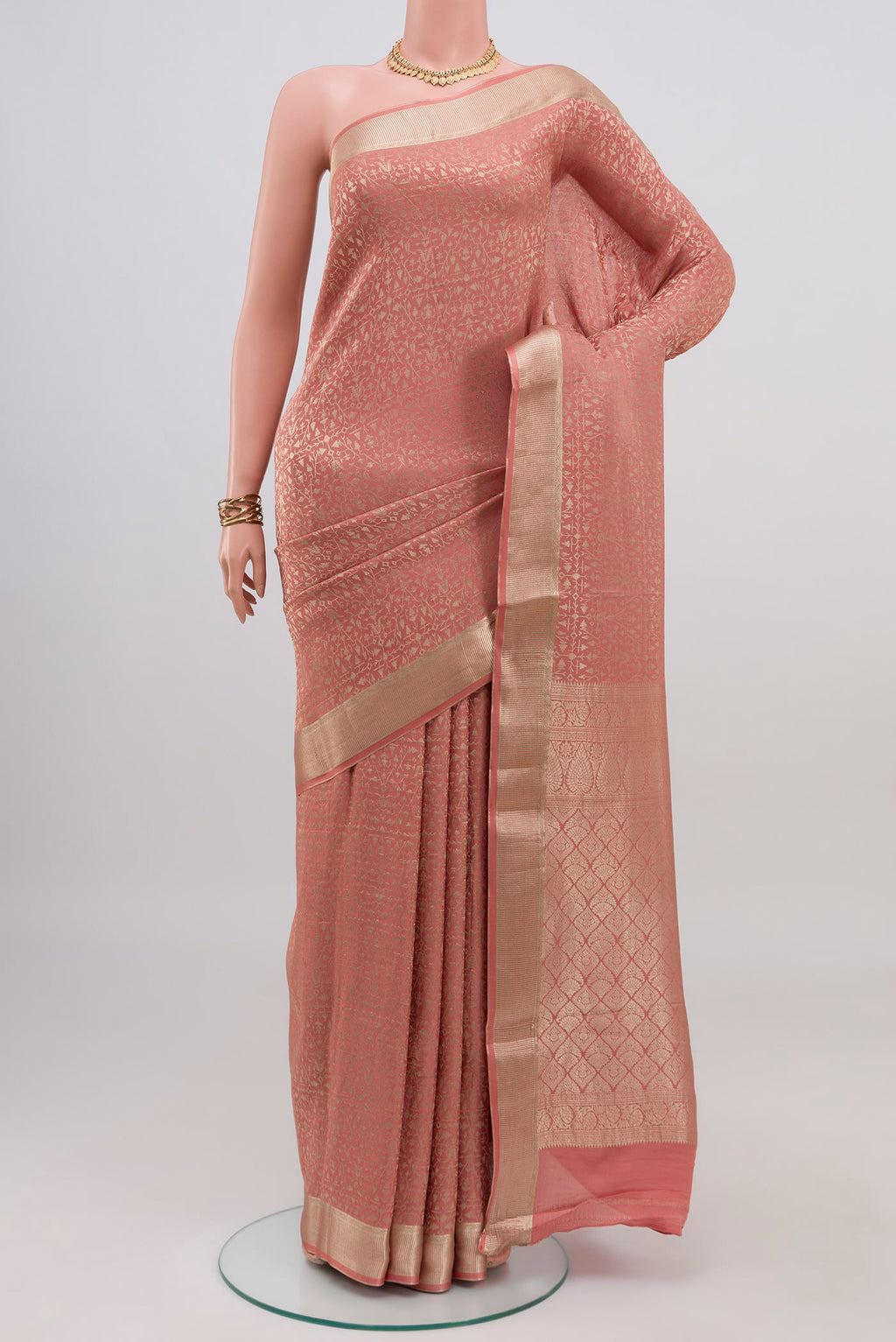 Peach Mysore Crepe Saree with Zari Brocade on the body and Zari Border.  displayed on a mannequin