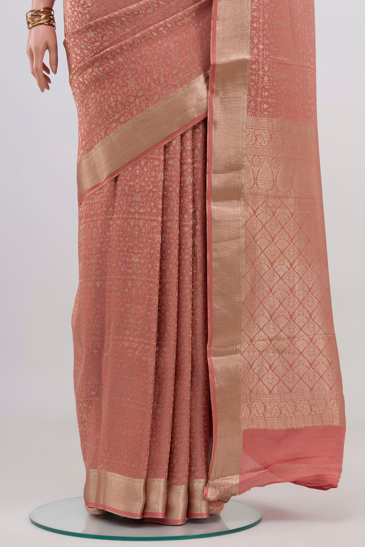 Pleats and pallu of Peach Mysore Crepe Saree with Zari Brocade on the body and Zari Border. 