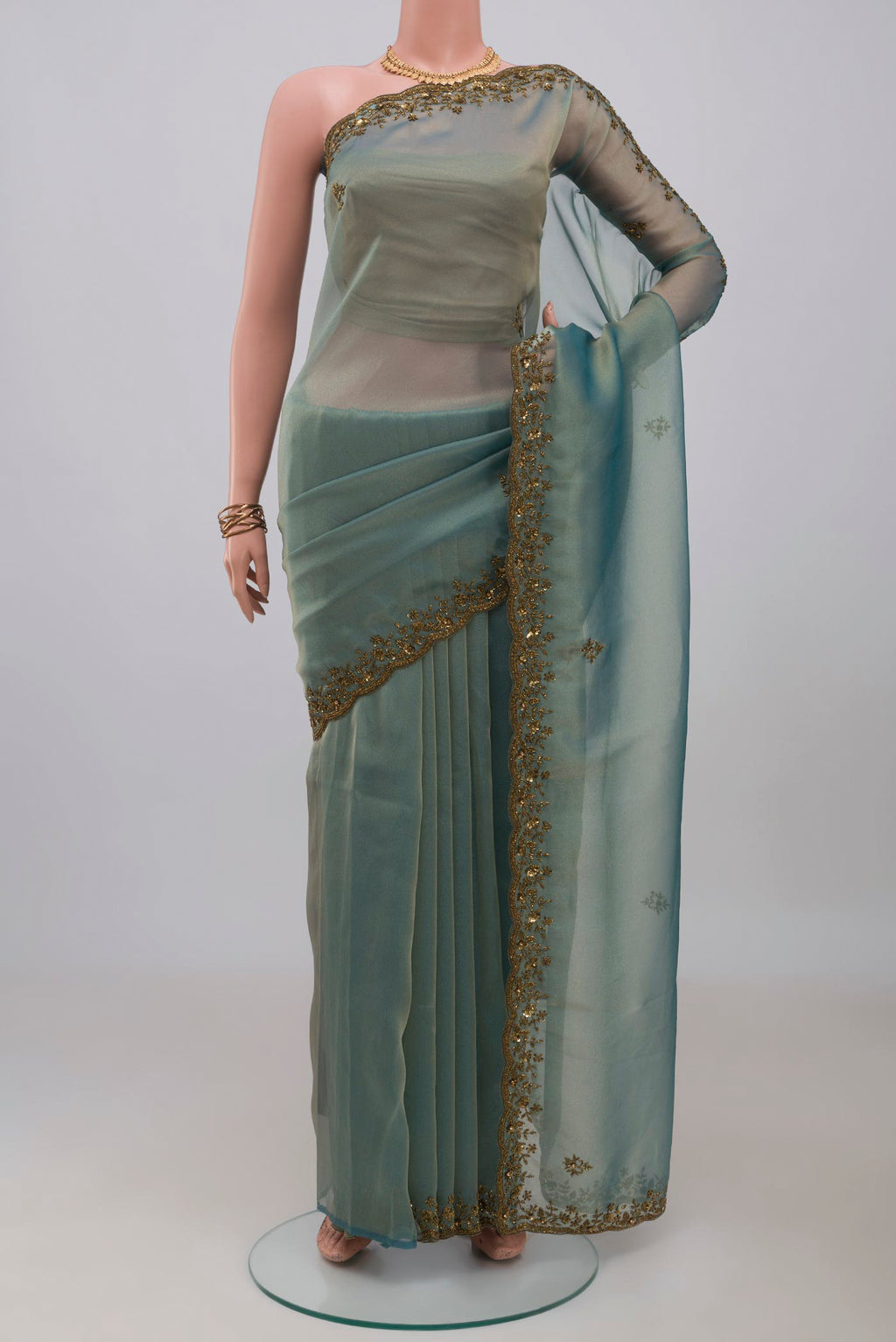Blue Grey Organza Silk Saree with Embroidery on the body and Embroidery Border.  displayed on a mannequin