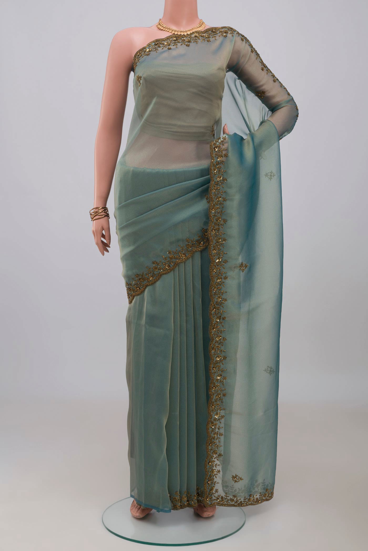 Blue Grey Organza Silk Saree with Embroidery on the body and Embroidery Border.  displayed on a mannequin