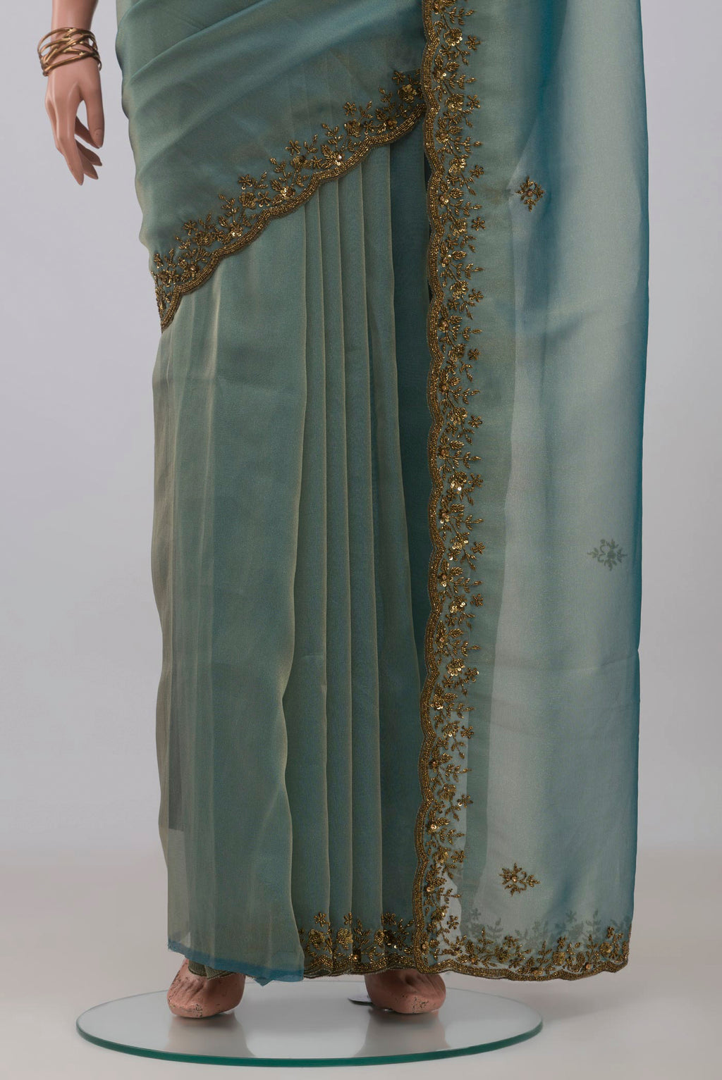 Pleats and pallu of Blue Grey Organza Silk Saree with Embroidery on the body and Embroidery Border. 